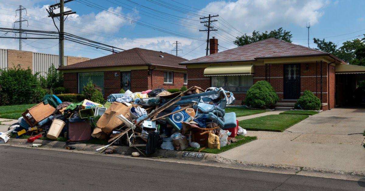 Home with pile of belongings outside due to recent eviction.