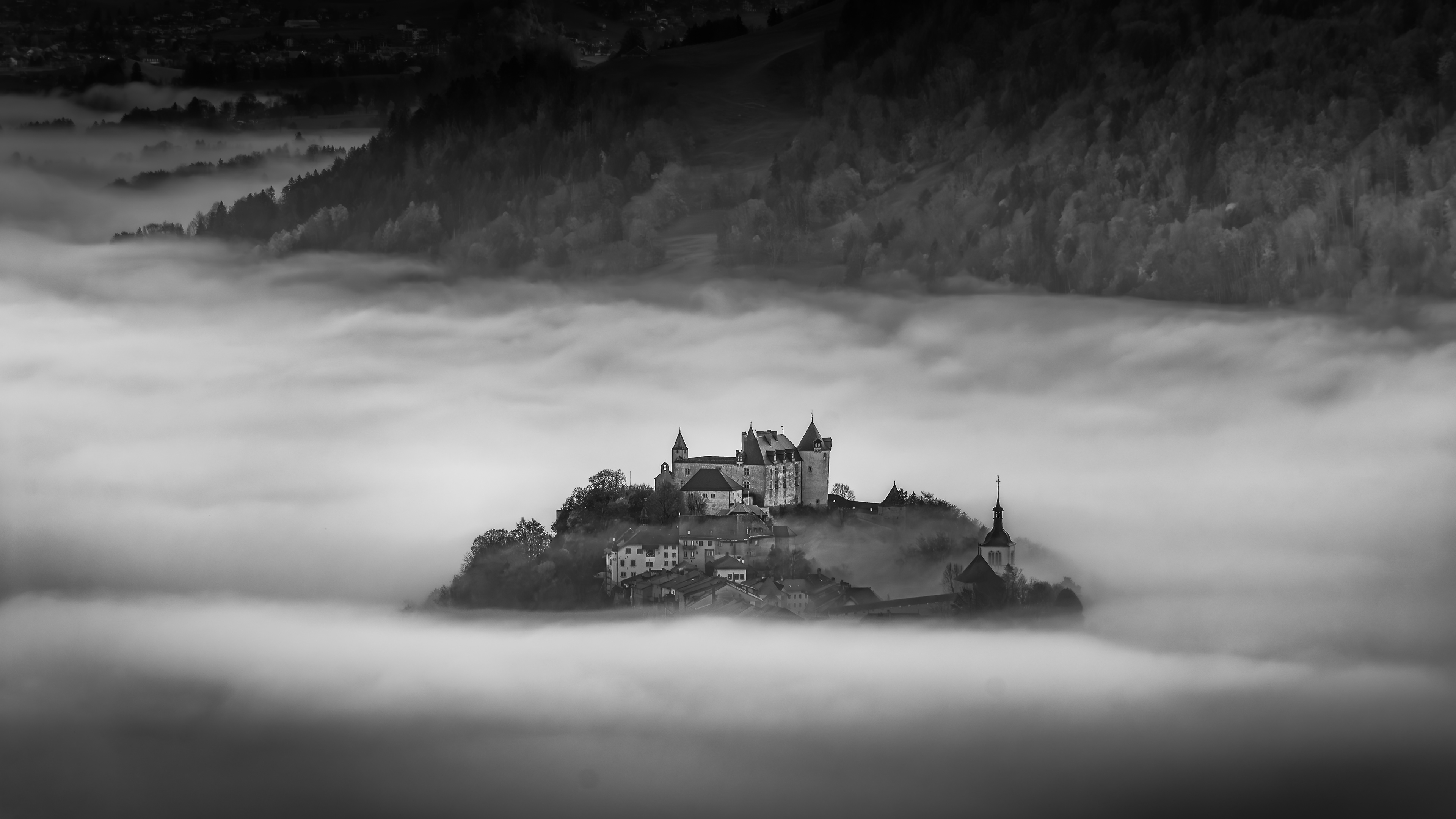 Gruyères emerging out of morning fog 