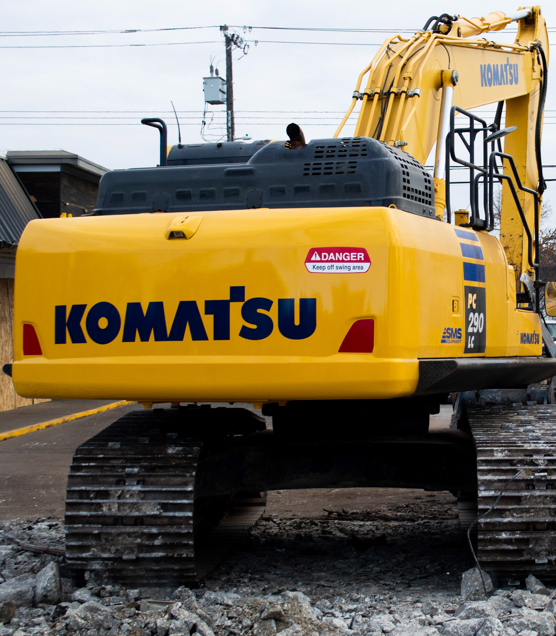 Rear shot of backhoe, showcasing the primary brand Grenier Brothers works with