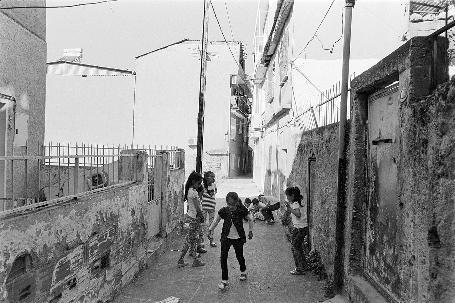 Children playing hopscotch on the streets of Kadifekale Mahallesi in Konak, İzmir., Türkiye.