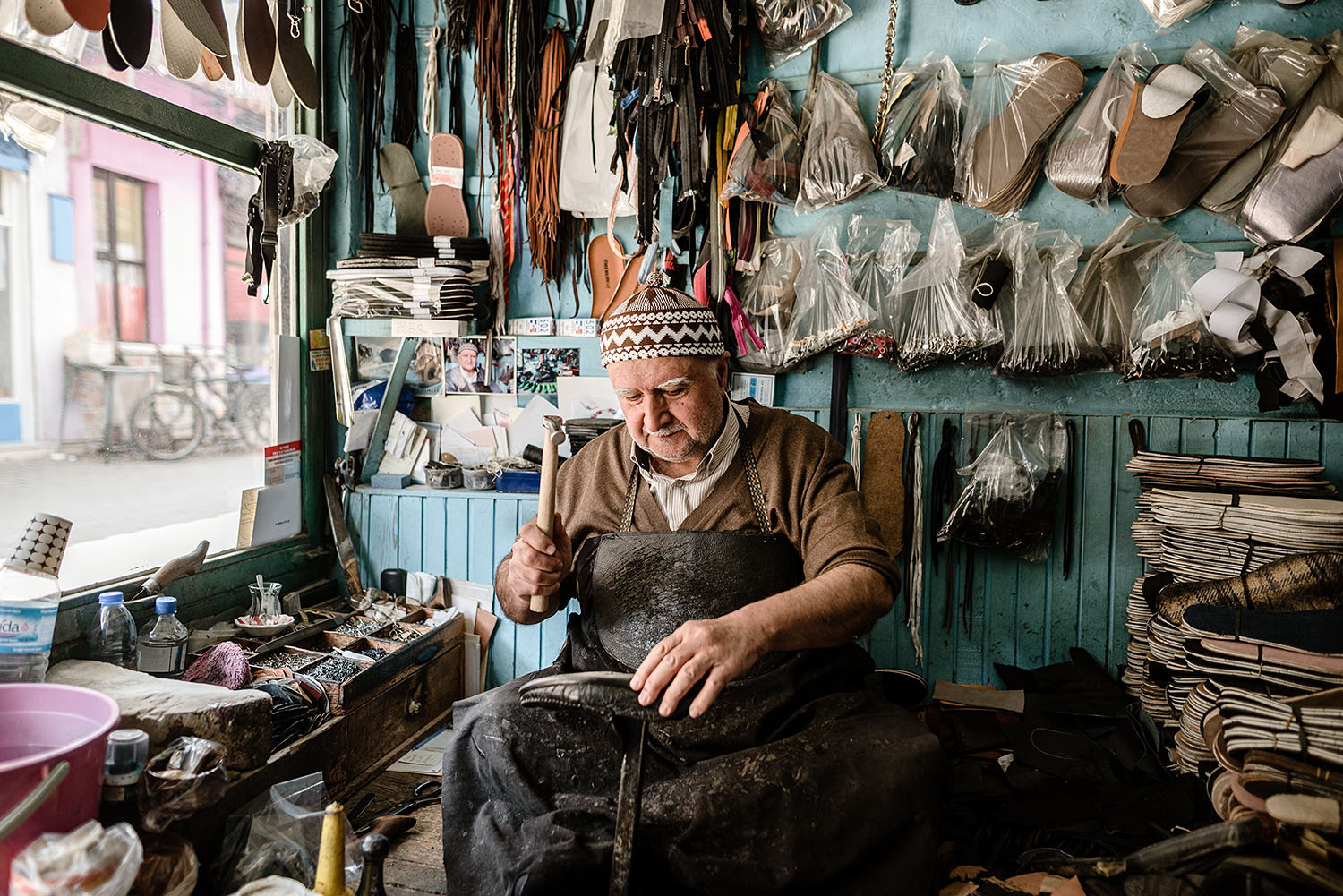 A shoemaker working on repairing a shoe.