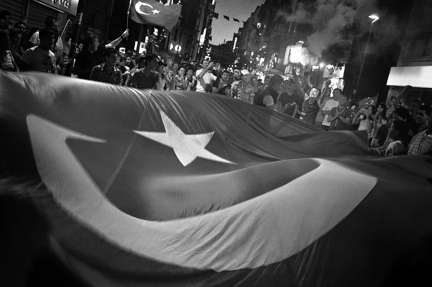 People protesting and waving Turkish flag on the streets of Karşıyaka in İzmir, Turkiye.