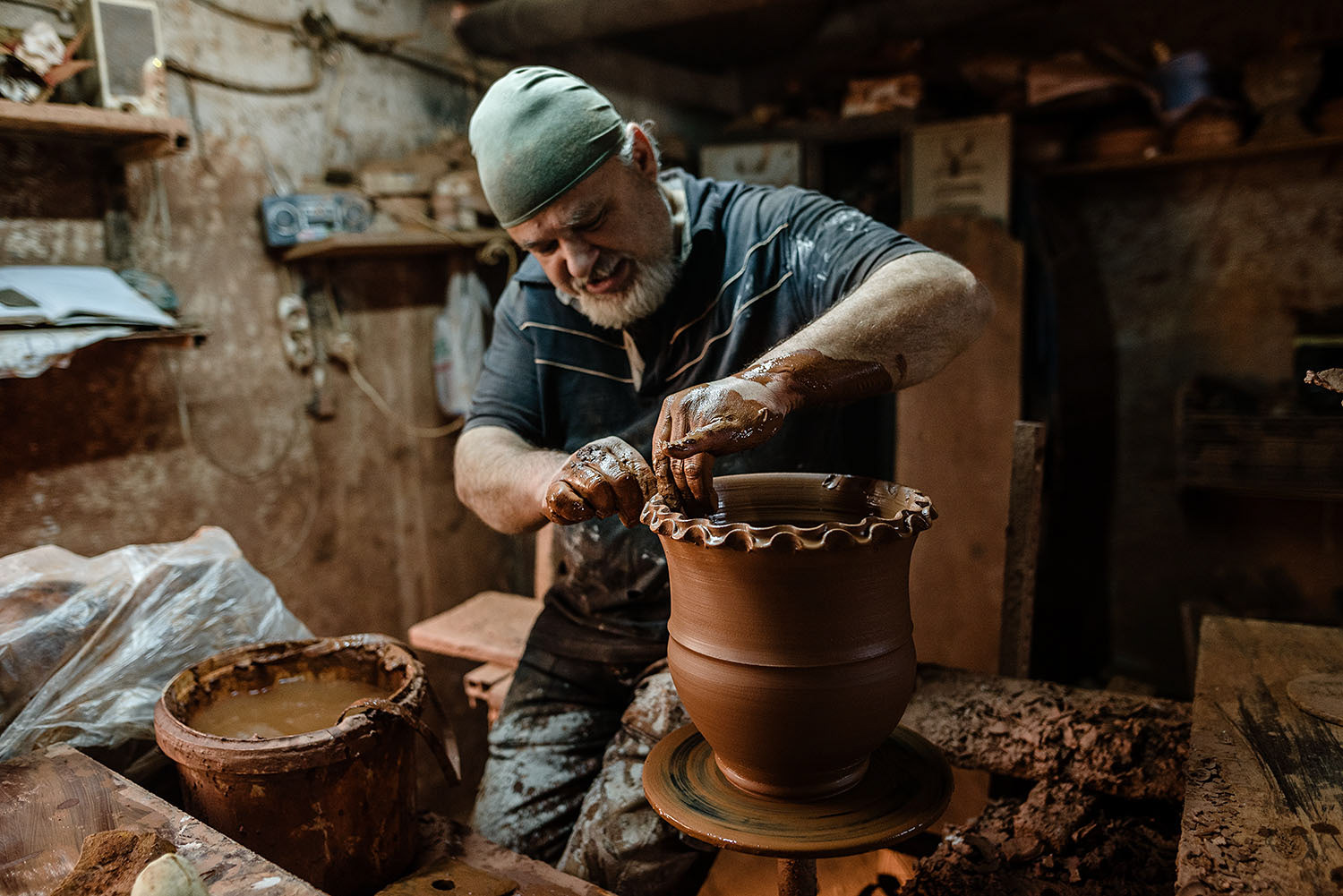 A master potter shaping a large clay pot.