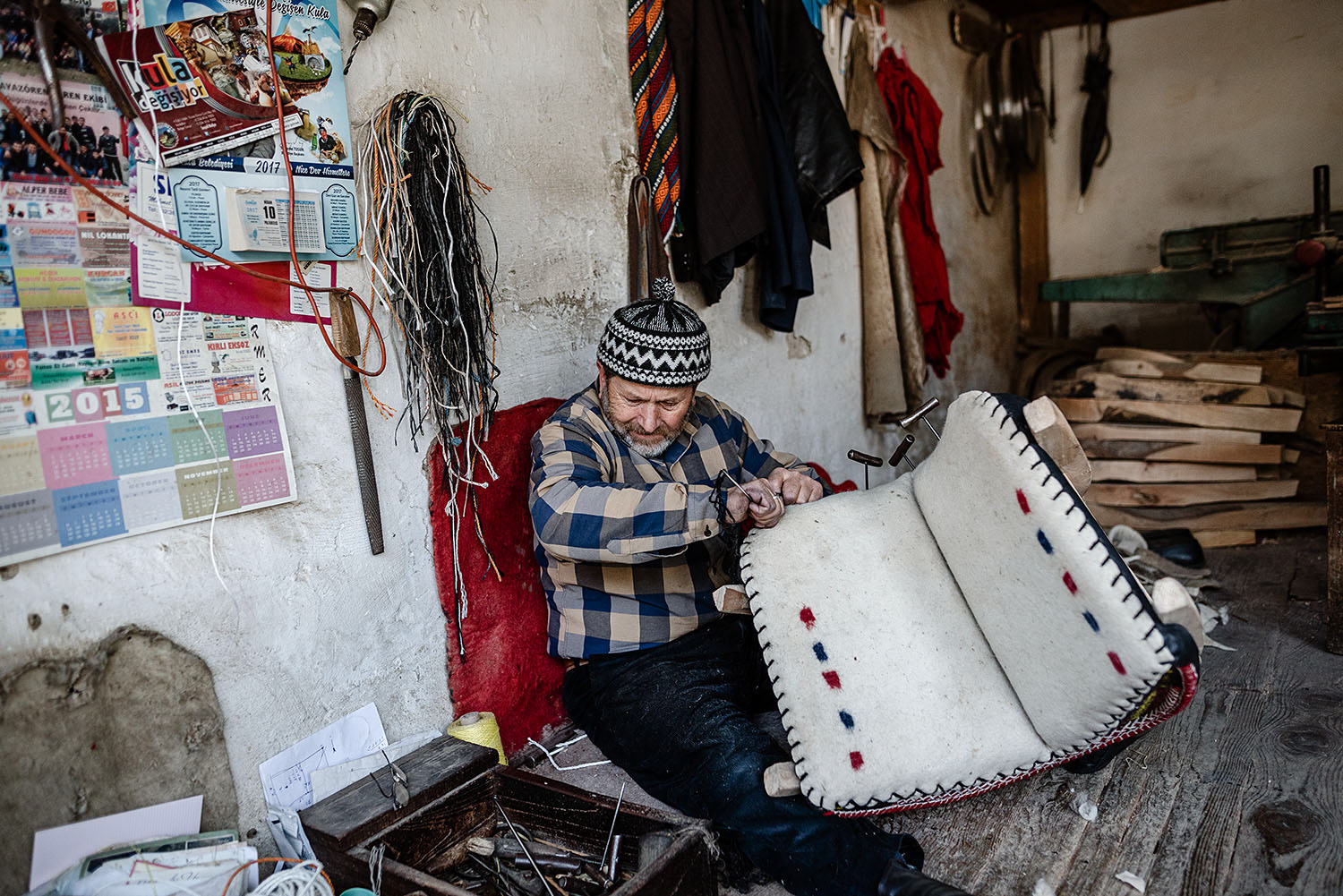 A saddlemaker or saddler in his workshop producing a saddle for horses and donkeys.