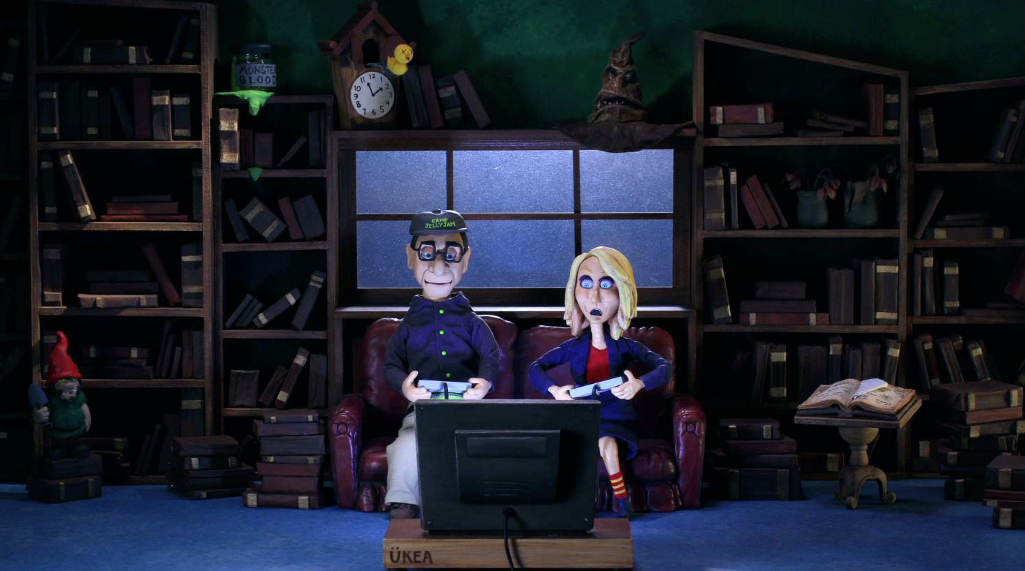 Screen still. Visible props: Cuckoo clock, bookshelves & books, monster blood. S1, E8 Video Games.