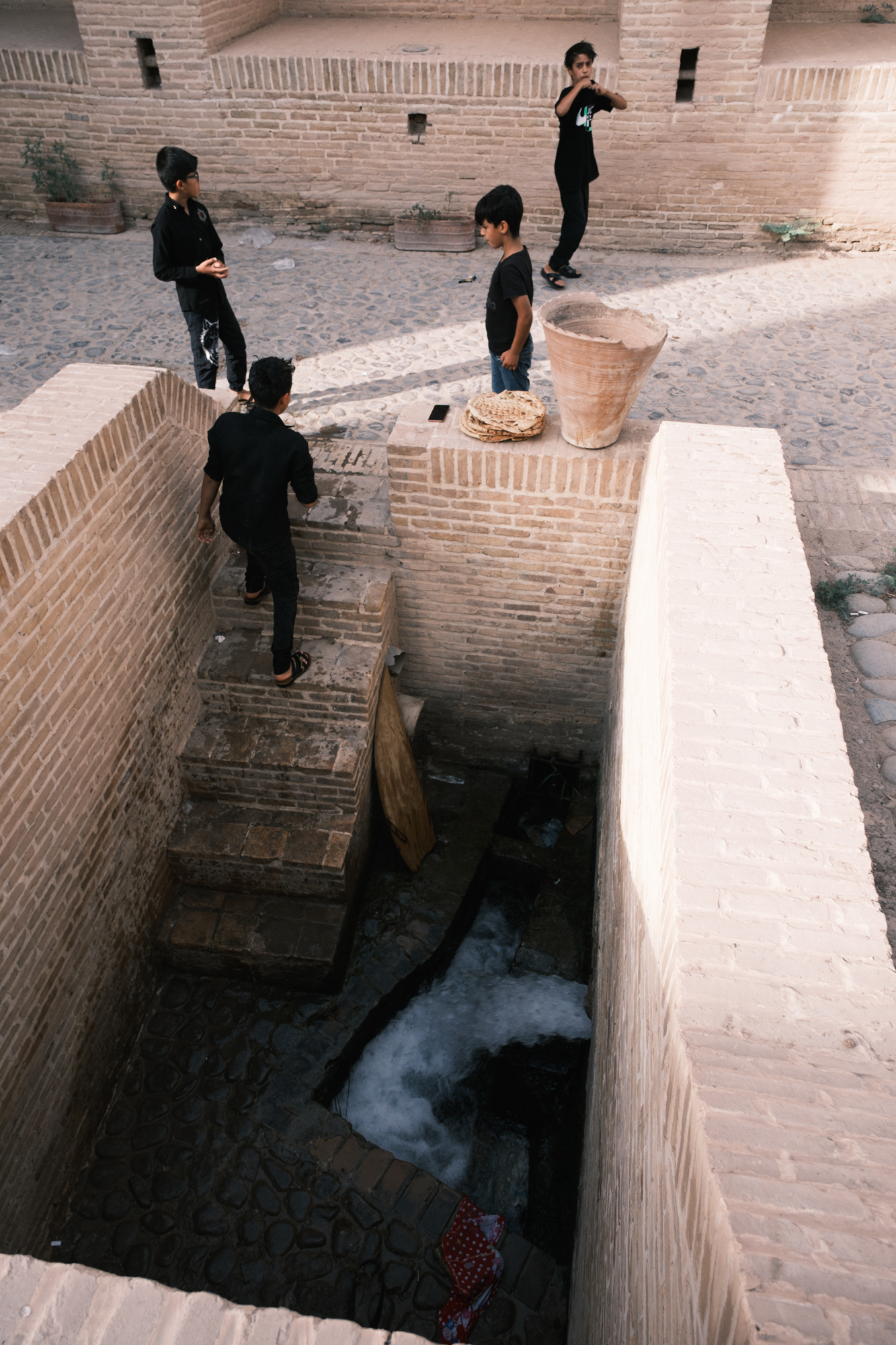 Boys cooling off with water from the qanat
