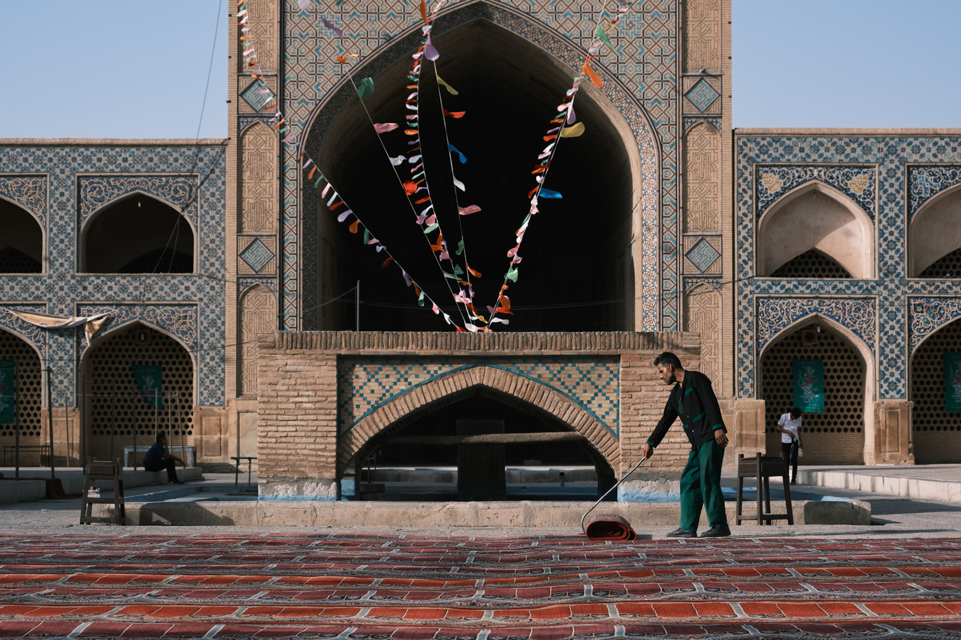 Laying carpets before Friday prayer
