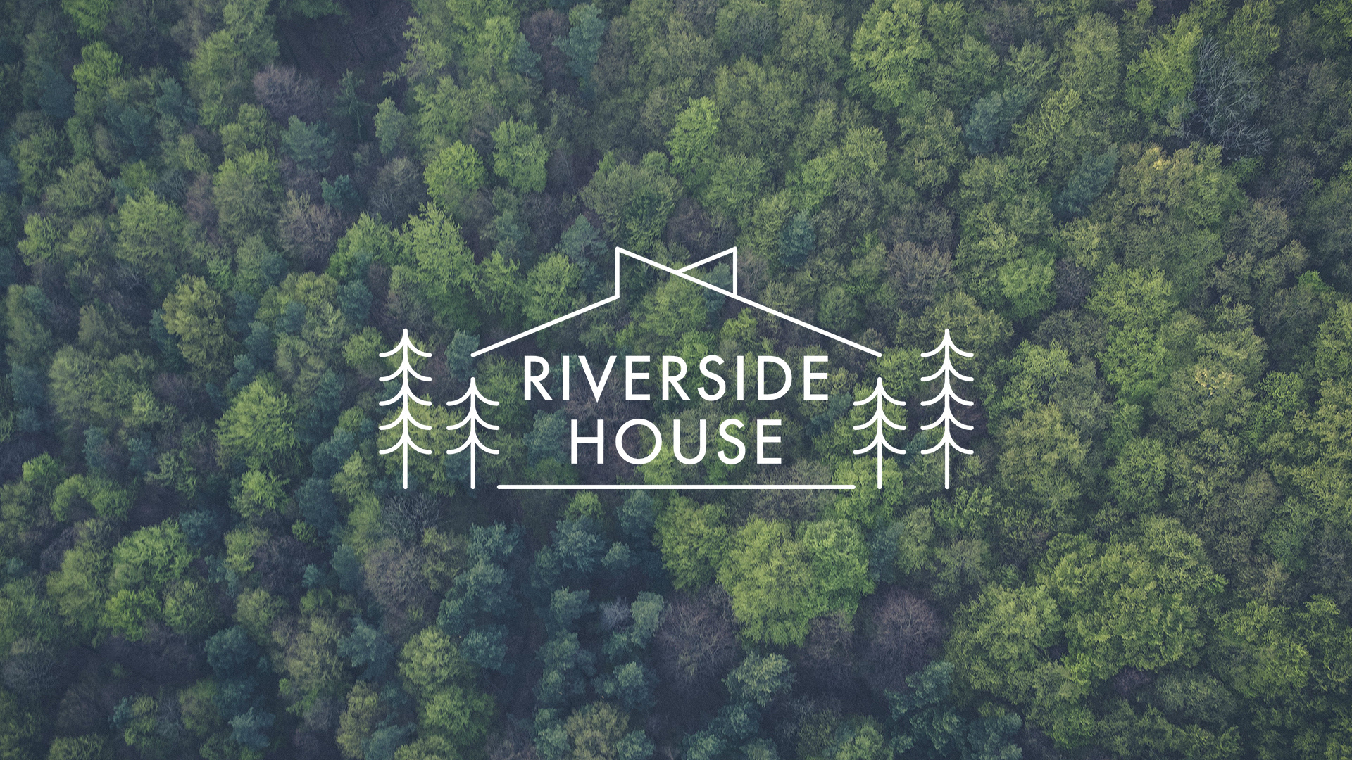 The RIVERSIDE HOUSE logo design over a moody aerial photograph of a dense green forest, showing a white line-art cabin silhouette and pine tree icons flanking stacked sans-serif typography.
