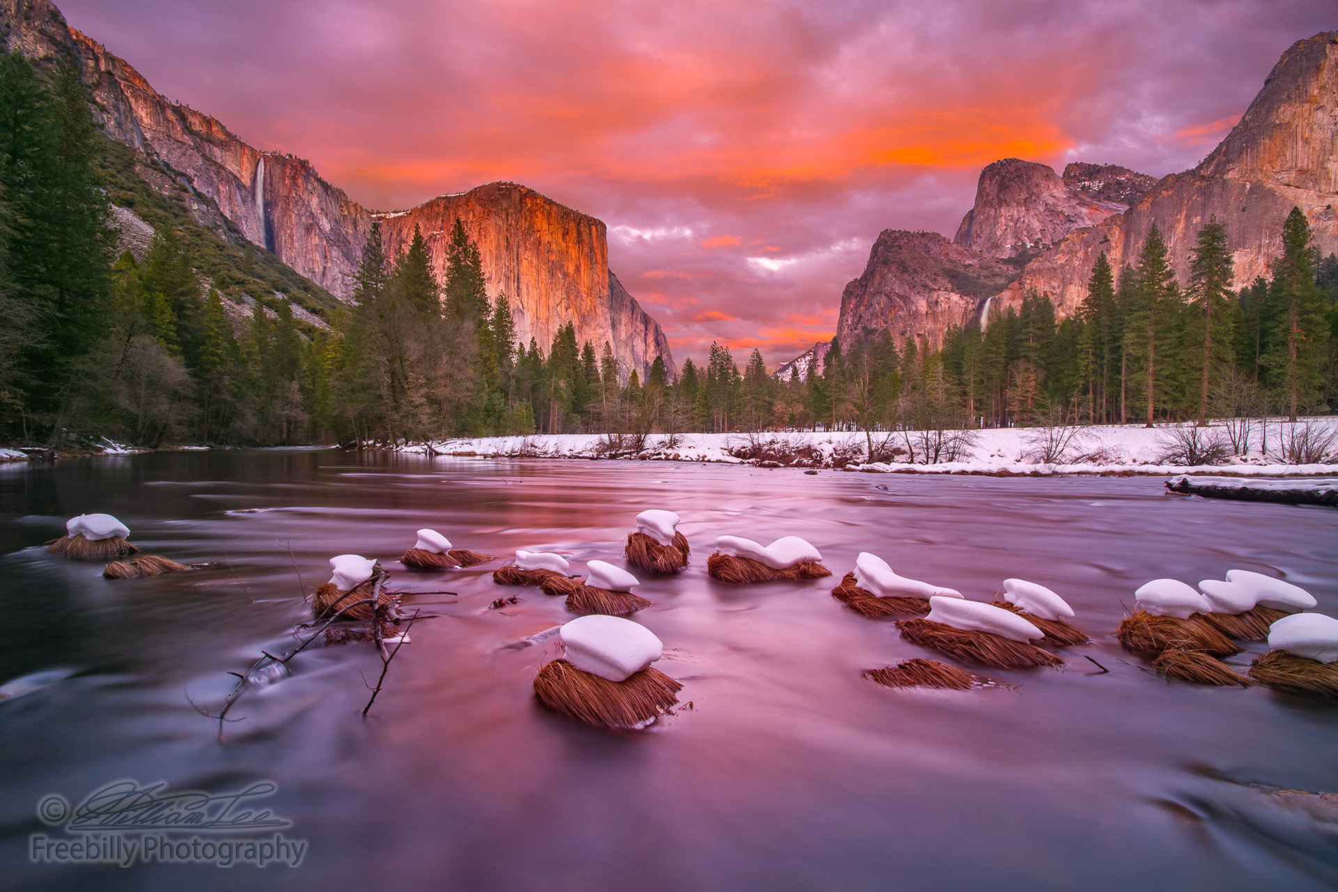 This is a photograph of Yosemite Valley at dusk with snow caps