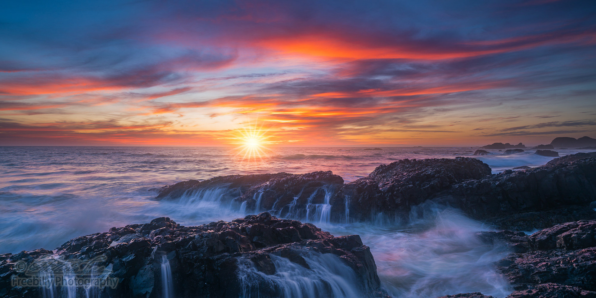This is a 2 to 1 ratio panoramic photo of Beluga rock sunset with beautiful clouds and ocean waterfalls