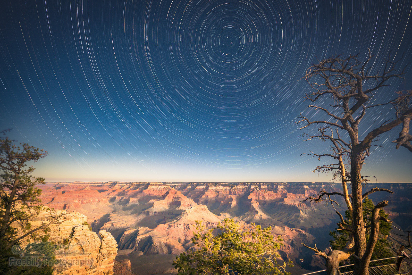 This is a night shot of Grand Canyon under moon light with star trails