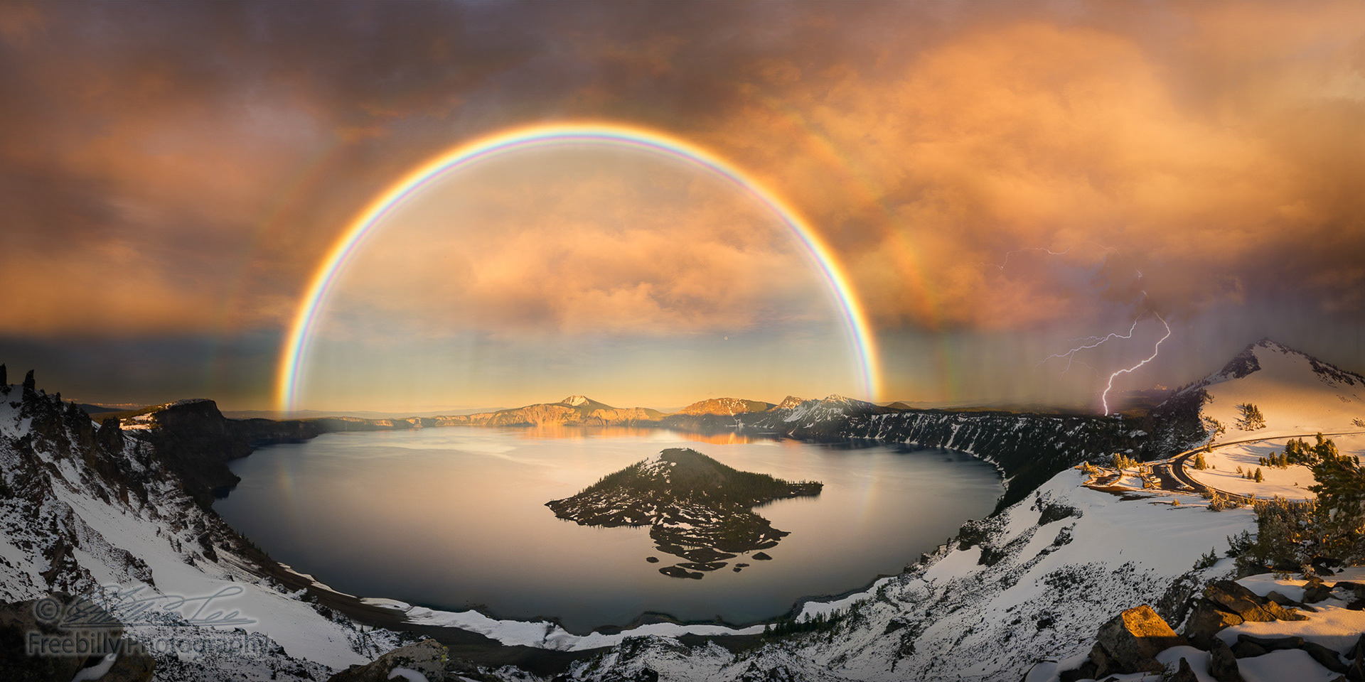 The panoramic view of Crater Lake with rainbow and lightning at sunset hour