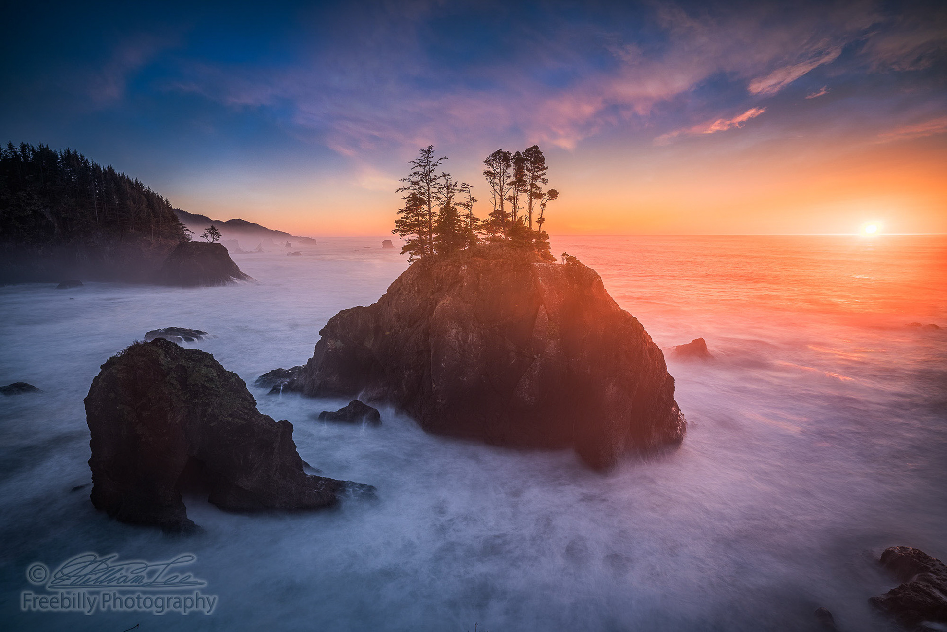 This is a wide angle shot of a colorful sunset and sea stacks view at Oregon coast, USA