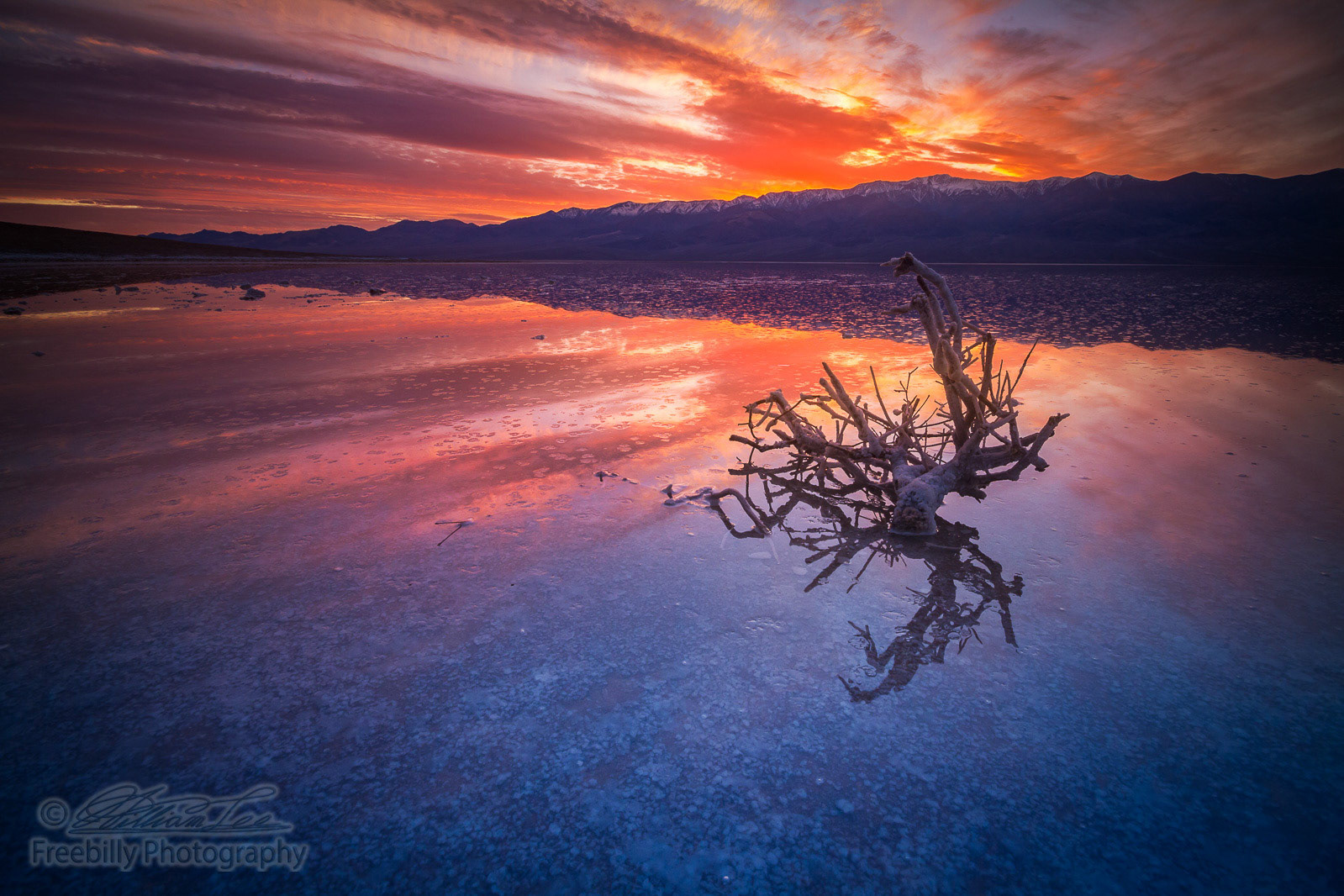 This is a photograph of Death Valley National Park with colorful clouds
