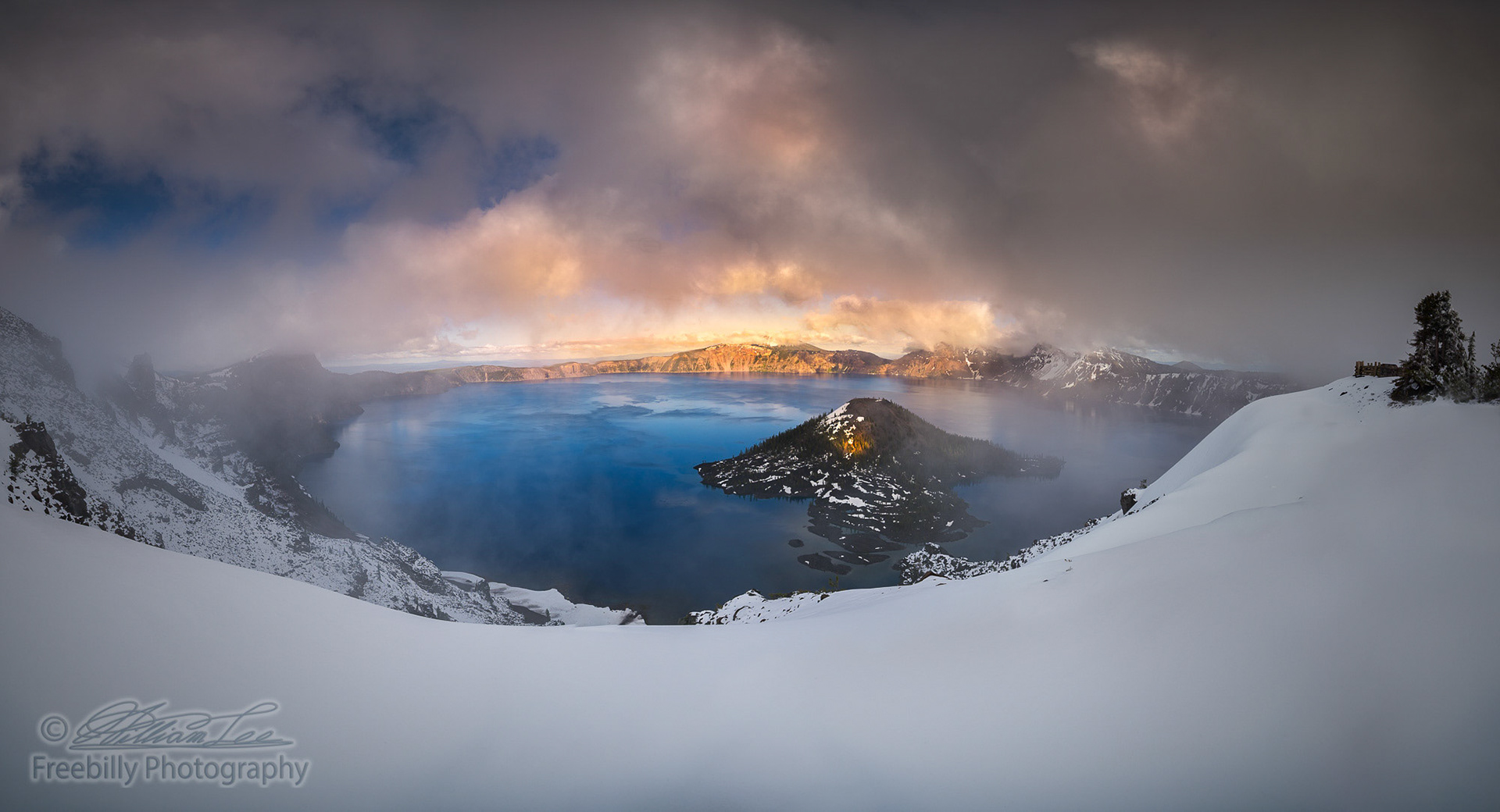 The panoramic view of Crater Lake in partial fog after snow storm