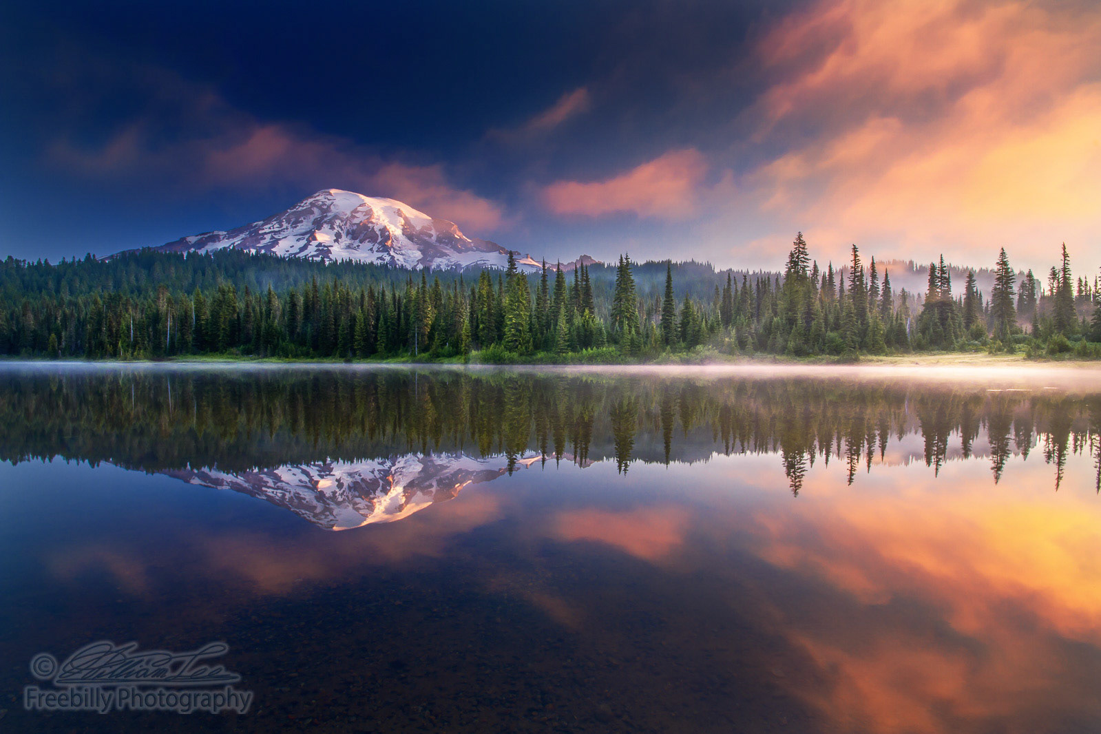 This photo was taken in a foggy early morning. The lake was so calm that it's like a mirror.