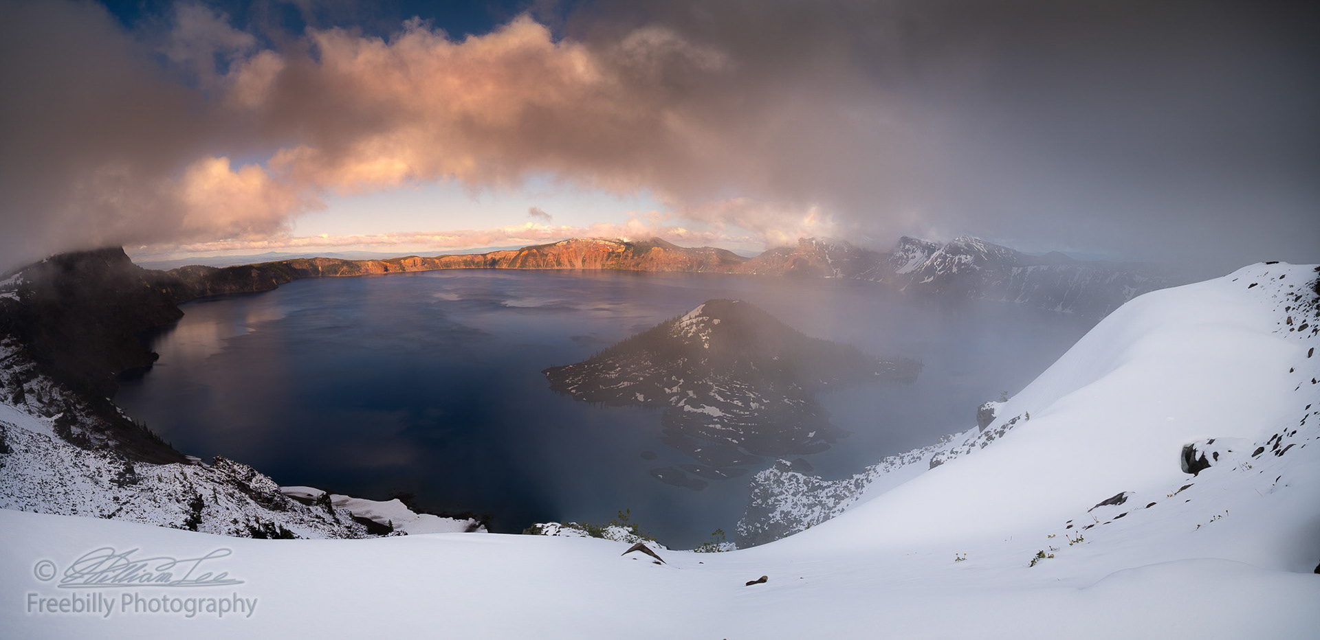 The panoramic view of Crater Lake in partial fog after snow storm
