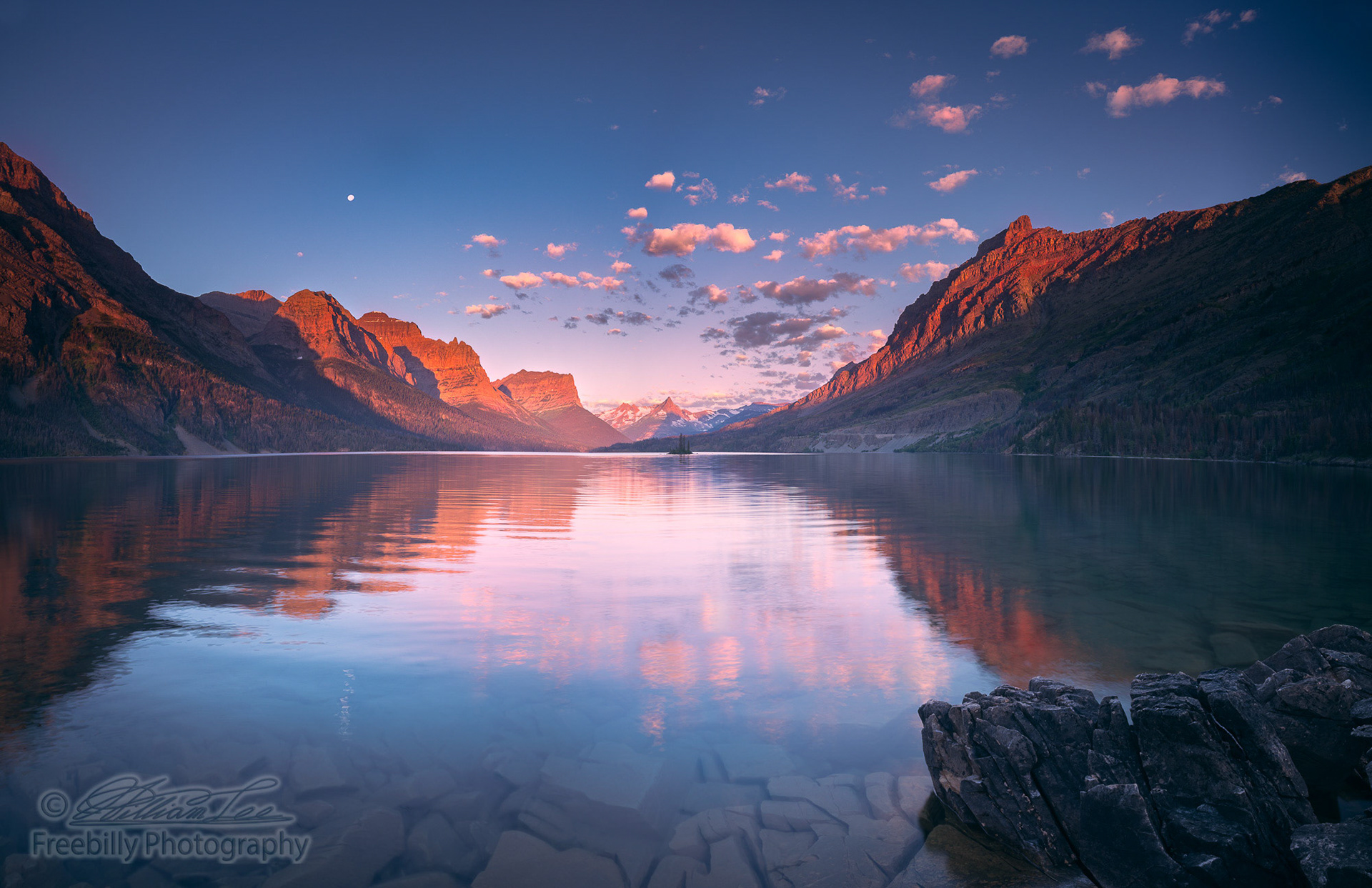 This is a panoramic view of the famous St Mary lake with moon at Glacier National Park.