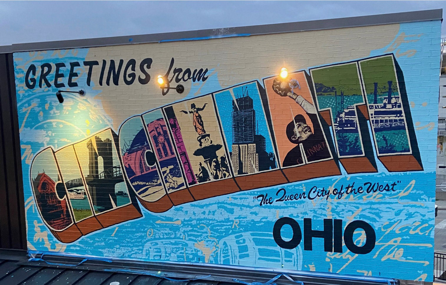 Greetings from Cincinnati/ The Banks, Cincinnati/ designed by Lightning Horse Industries/ produced by Jim Tucker and the ArtWorks Mural Studio/ 2022
