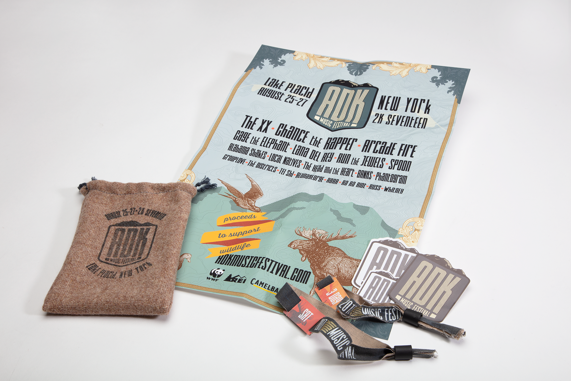 Sticker pack, RFID bracelets, information foldout with lineup poster on back. All tucked inside a reusable branded pouch.