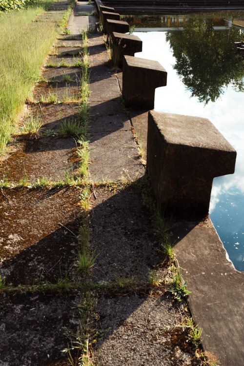 Urbanes Detail. Abgenutzte Startblöcke mit Schattenwurf im Strombad Cottbus