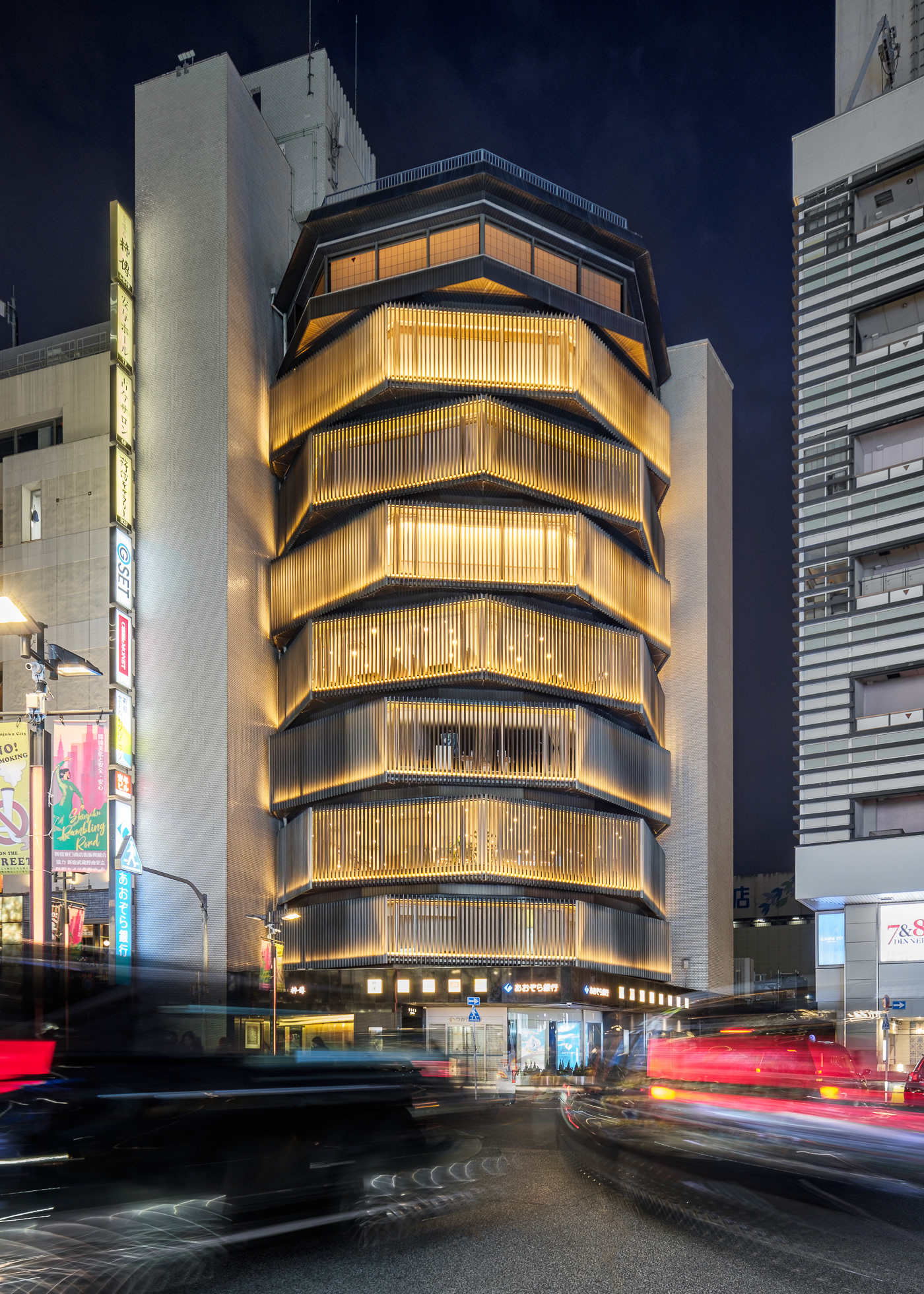 Yasuyo Hall, designed by Kengo Kuma, is a refined architectural space located at Meiji Gakuin University in Shinjuku, Tokyo, Japan. Featuring Kuma’s signature use of natural wood, the hall seamlessly blends traditional craftsmanship with contemporary design. Its carefully layered structure allows for a dynamic interplay of light, texture, and spatial rhythm, creating a warm and inviting atmosphere. Captured by Sections Architectural and Interior Photography, showcasing its elegant materiality, fluidity, and architectural innovation.