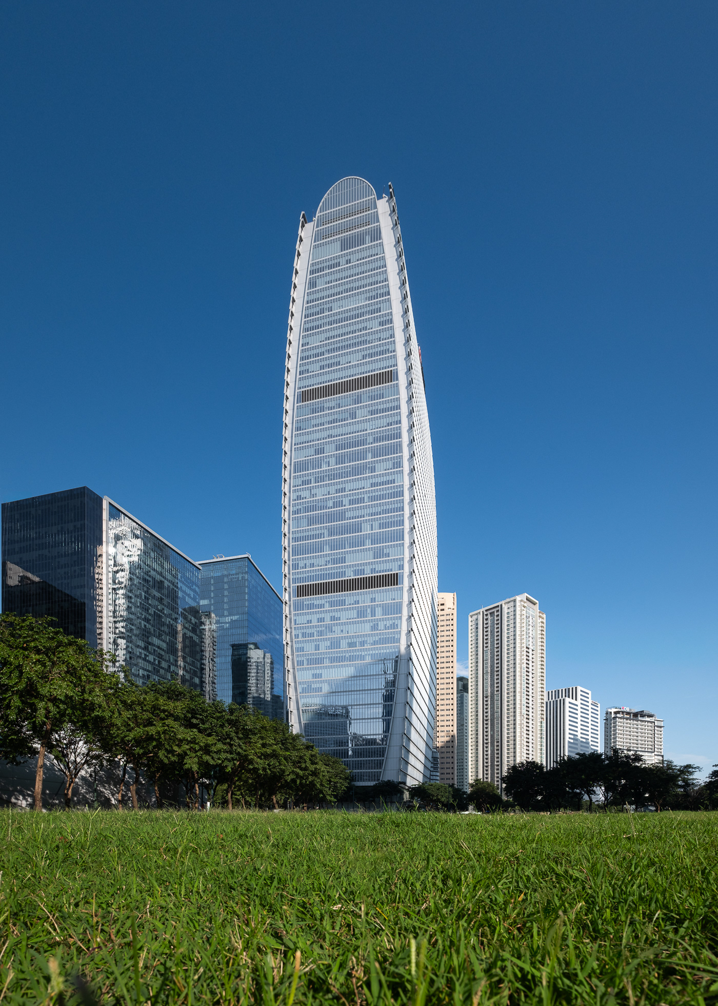 The Finance Centre, a premier Grade A office tower in Bonifacio Global City (BGC), Philippines, exemplifies modern corporate architecture and sustainable design. Developed by The Net Group and designed by Gensler, the building features an elegant glass façade, energy-efficient systems, and expansive column-free office spaces, creating a flexible and dynamic work environment. Captured by Sections Architectural and Interior Photography, showcasing its sophisticated design, structural innovation, and urban presence.
