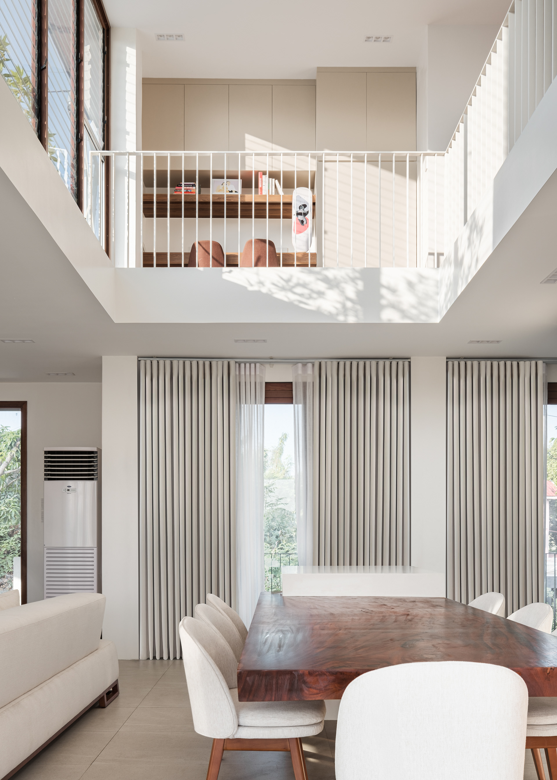 Designed by Reyes Architecture, this residential home embodies clean lines, openness, and a bright, inviting ambiance. The thoughtfully designed structure maximizes natural light and ventilation, with jalousie windows enhancing both function and aesthetics. Its spacious layout creates a seamless flow, offering a sense of ease and comfort. Captured by Sections Architectural and Interior Photography, showcasing its architectural form, airy interiors, and refined simplicity.