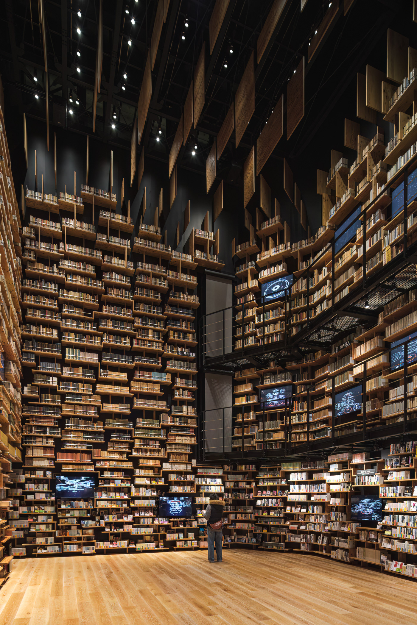 Inside the Kadokawa Musashino Museum, the Bookshelf Theater—a breathtaking library designed by Kengo Kuma—blends literature and architecture into an immersive experience. Towering 8-meter bookshelves envelop visitors in a warm, golden glow, creating a space where light, texture, and knowledge converge. Captured by Sections Architectural and Interior Photography, showcasing the library’s dramatic scale and atmospheric design.