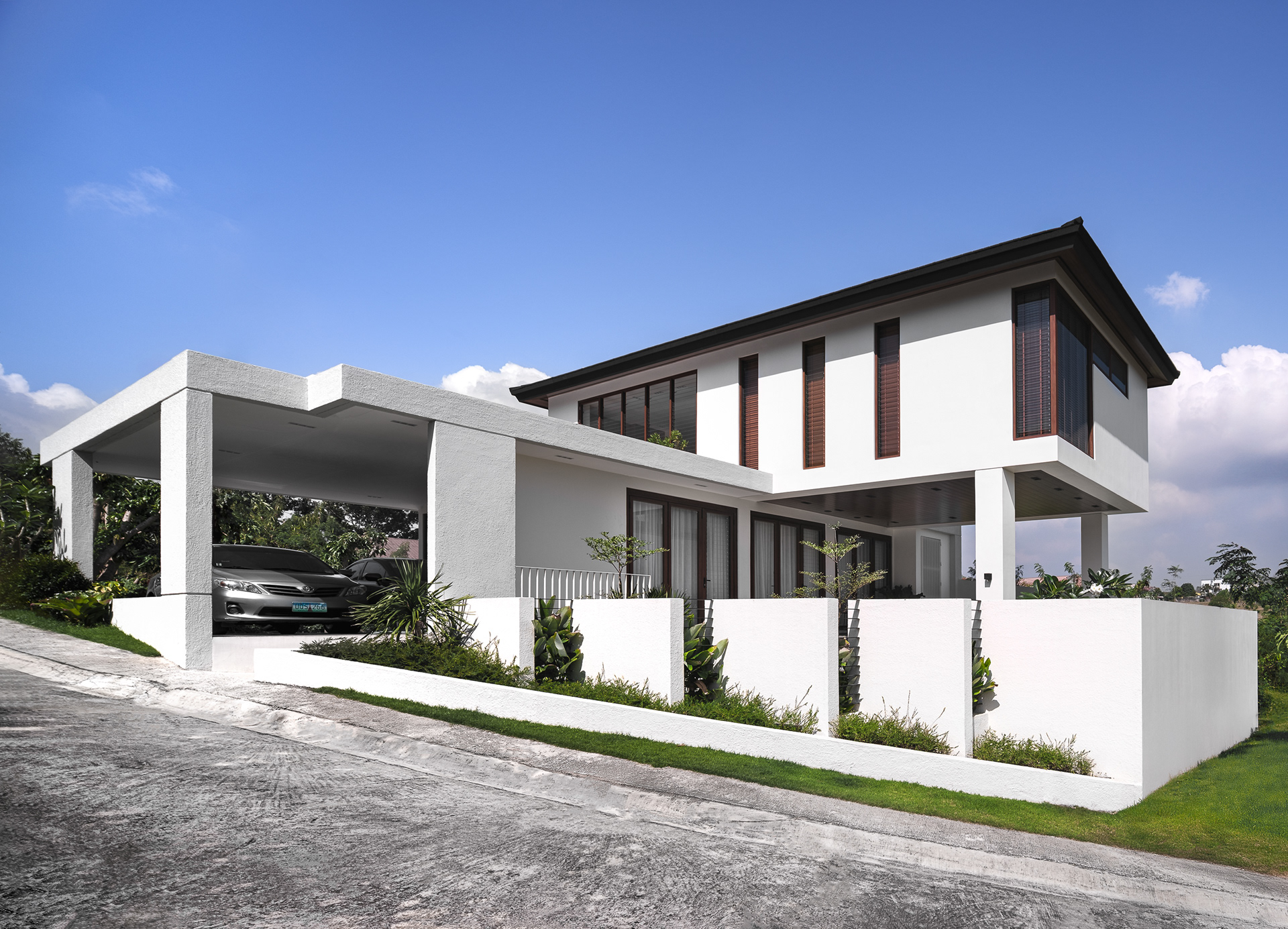 Designed by Reyes Architecture, this residential home embodies clean lines, openness, and a bright, inviting ambiance. The thoughtfully designed structure maximizes natural light and ventilation, with jalousie windows enhancing both function and aesthetics. Its spacious layout creates a seamless flow, offering a sense of ease and comfort. Captured by Sections Architectural and Interior Photography, showcasing its architectural form, airy interiors, and refined simplicity.