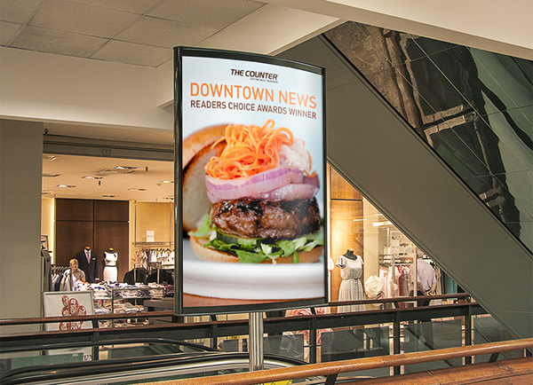 A large printed sign that is found in select malls near The Counter restaurants. I designed the sign with large imagery of burgers to capture viewers' attention.