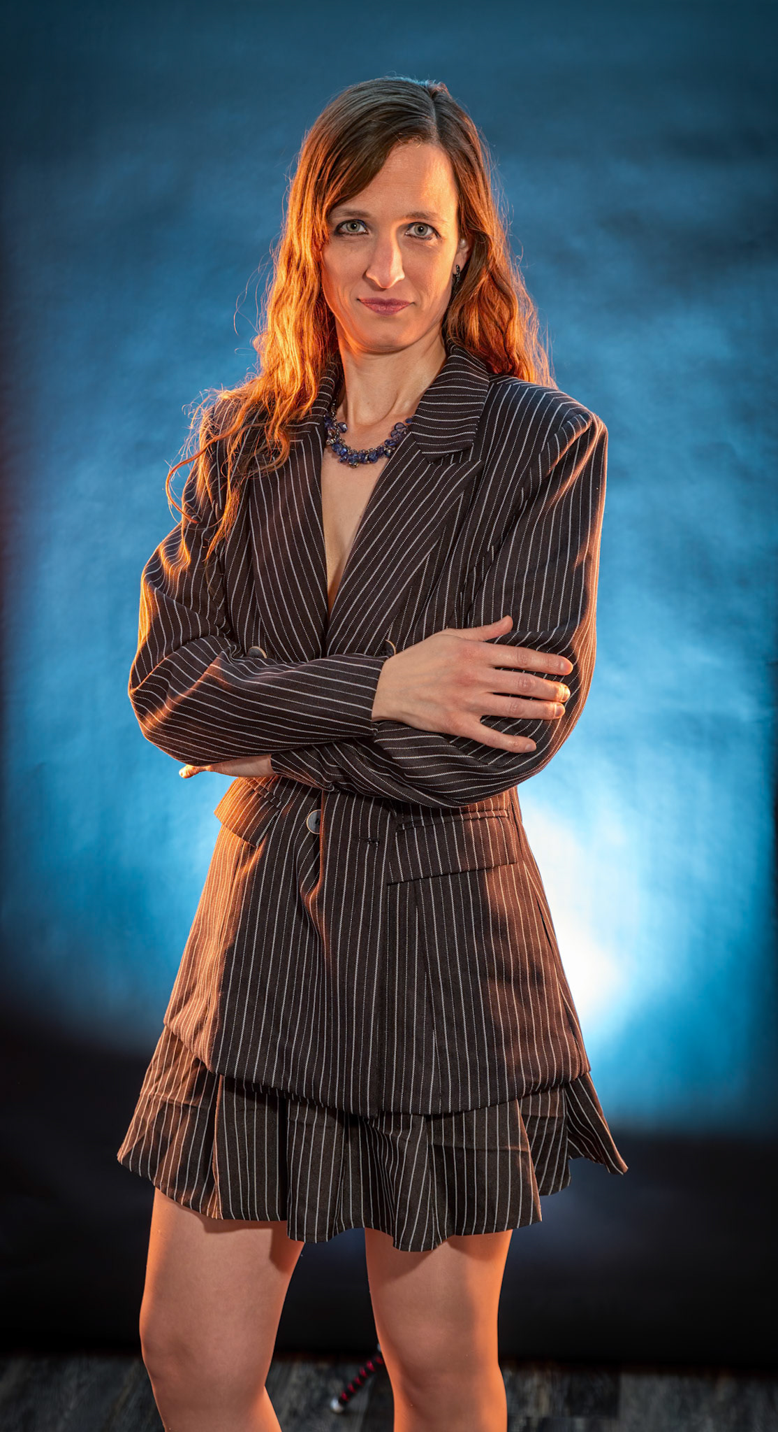 Short Skirt and a Long Jacket - Arms Crossed: Cake themed shoot today, lit by the sides by Godox AD200 pros in 30x120 softboxes with yellow gel. Backlight lit by V1 with a blue gel. Main flash also a V1 with a grid and white cloth softener.