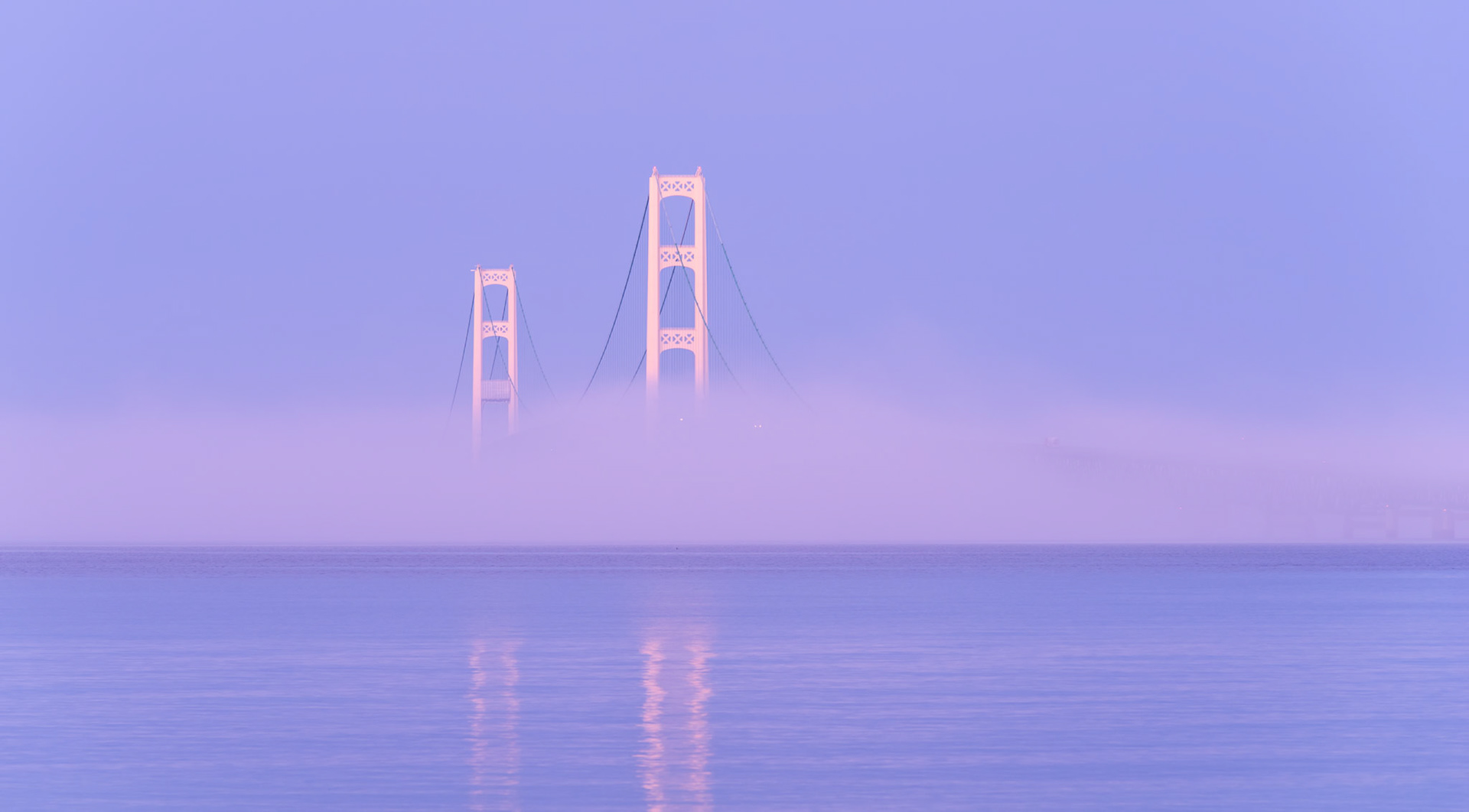 Mackinac Bridge In Fog: As we packed up in the morning, we watched some fog roll into the straits, covering the bridge. Twenty minutes later, the fog rolled back out, leading to a quick shot or two of the bridge poking out of the fog.