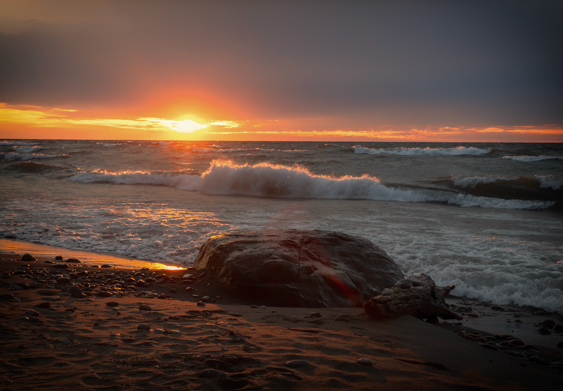 A Brief Sunset Amongst Clouds and Waves: Sometimes waiting that extra time is worth it, when the sun peaks through the clouds just right.