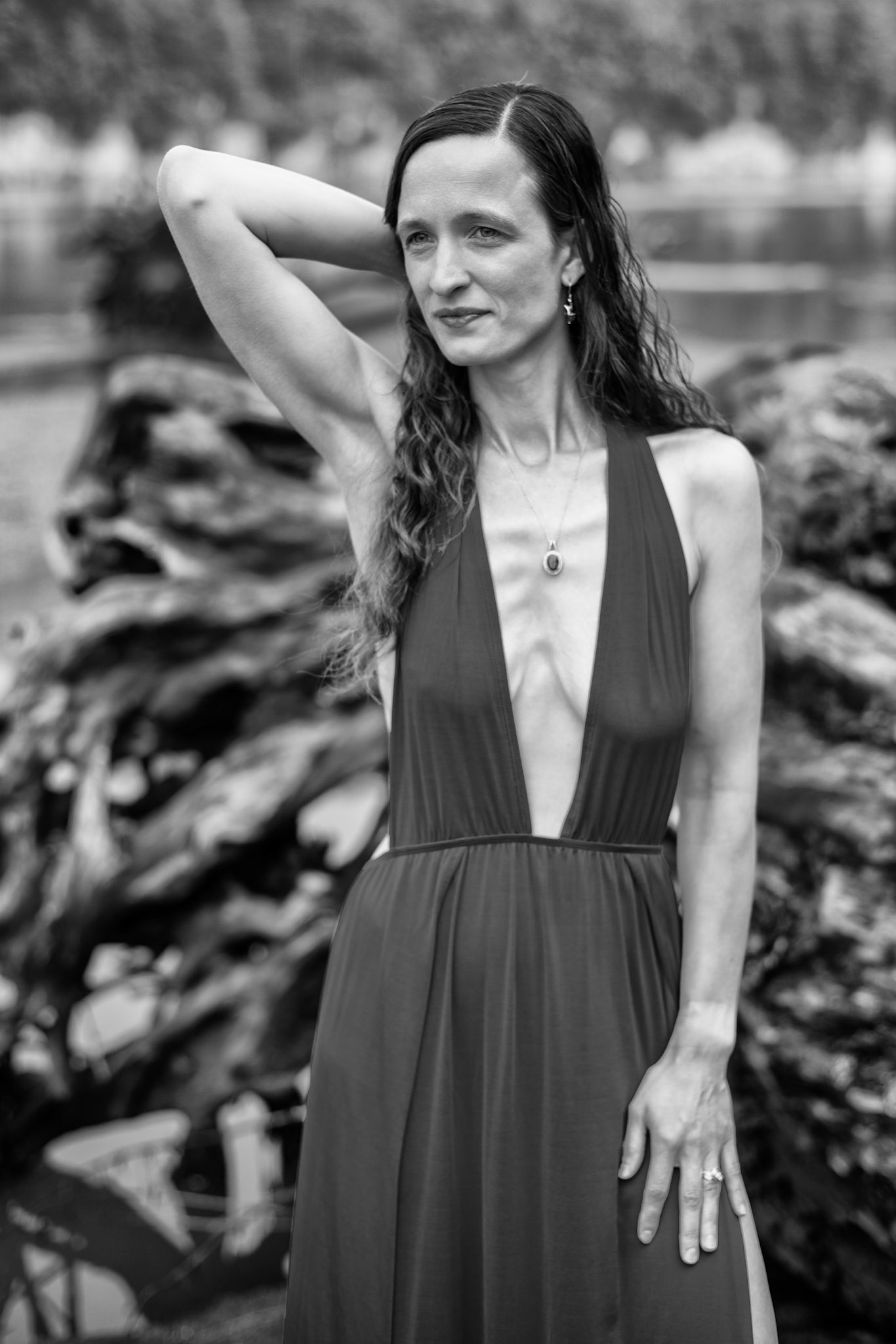 Serene Nature and Red: Crimson Passage (B&amp;W): The journey unfolds between water and stone. The movement is guided by the fabric’s liquid fall, transforming a simple walk into a tableau of heightened presence.