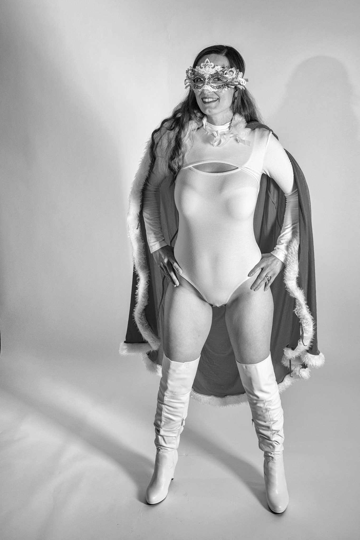 Super Heroine: Masked, Caped, Unbothered - Playing with the bright, comic-inspired side of portraiture — bold color, clean lines, and a touch of mystery.Setup: V1 snoot for key, V1 strip for fill, AD200 red gel for background.