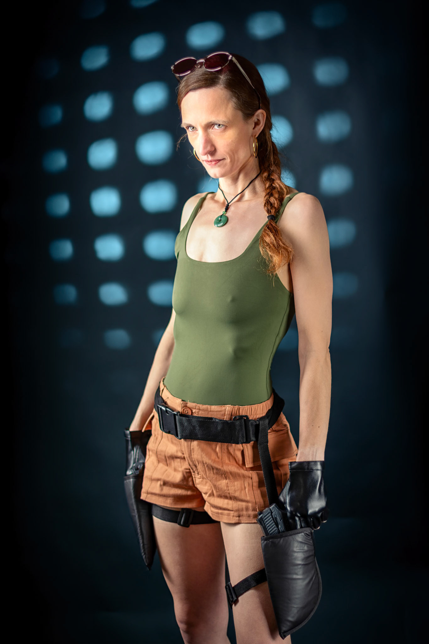 Lara Croft: Tactical Readiness: Textures of leather, fabric, and skin are brought into high relief through precise studio lighting. The abstract background provides a cinematic depth that elevates the iconic adventurer aesthetic into the realm of fine art.