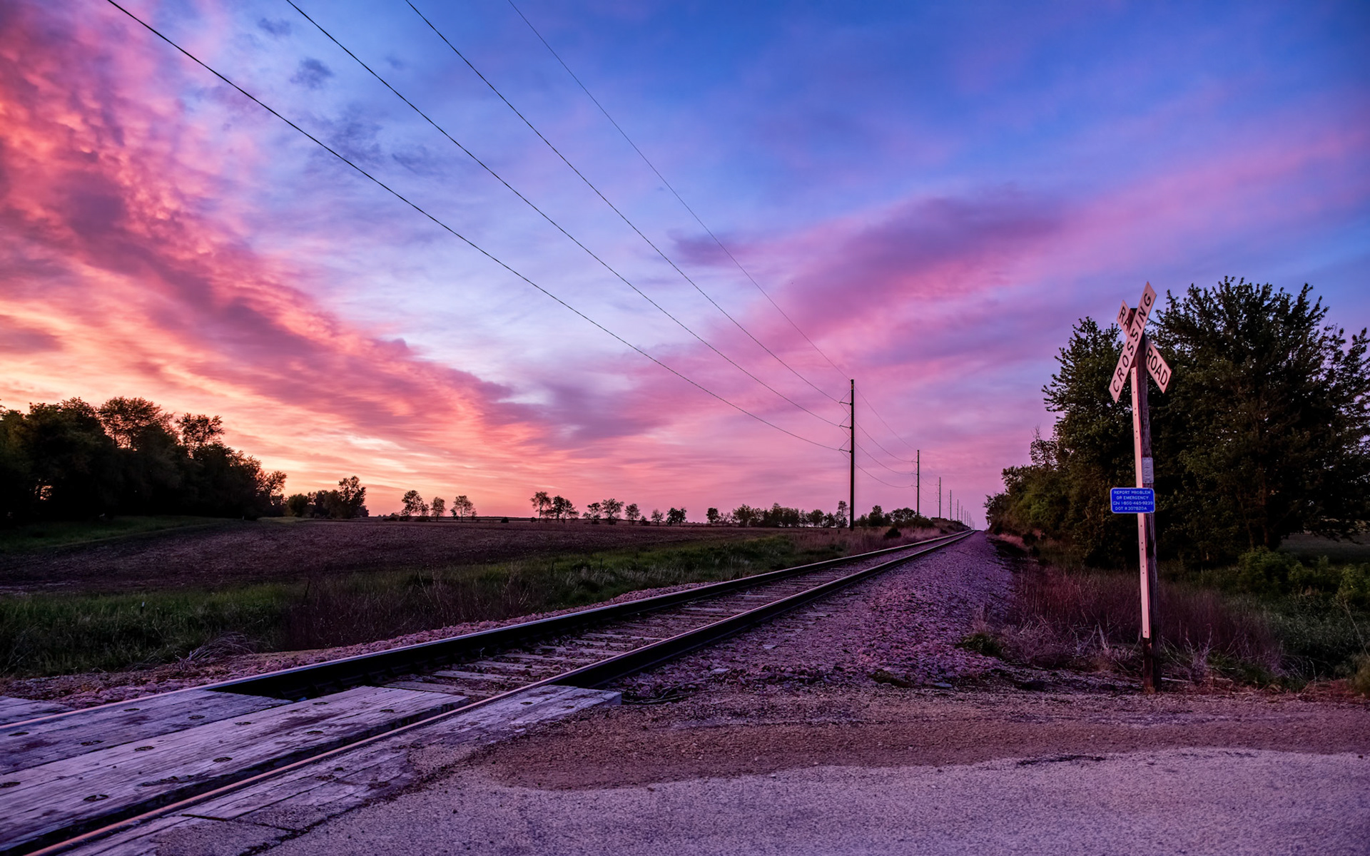 22:52 - Sunset Express: With a forecast of a day of rain followed by clouds breaking up near sunset, I knew we were in for a gorgeous sunset if we were lucky. After driving around, I almost missed it as I detoured through residential neighborhoods to avoid a major road closure. Luckily, I stumbled down a side street to this random railroad crossing over a gravel road and managed to capture a few shots right before my camera batteries died! Worth it though!