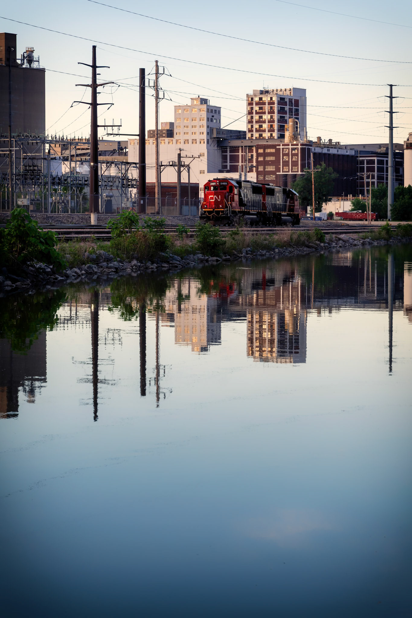 Metropolis Fragments - Industrial Echo: Exploration of repetition and scale. The mirroring effect transforms a gritty railway scene into a balanced, architectural abstract.