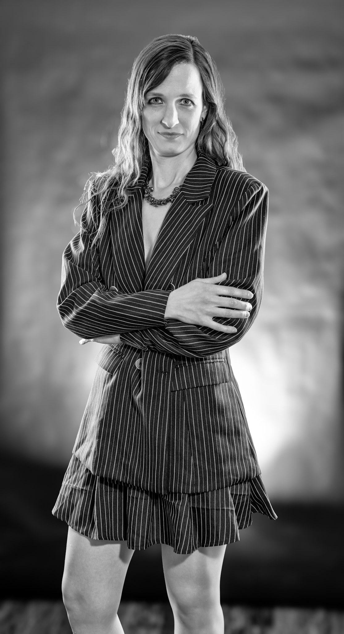 Short Skirt and a Long Jacket - Arms Crossed (B&amp;W): Cake themed shoot today, lit by the sides by Godox AD200 pros in 30x120 softboxes with yellow gel. Backlight lit by V1 with a blue gel. Main flash also a V1 with a grid and white cloth softener.