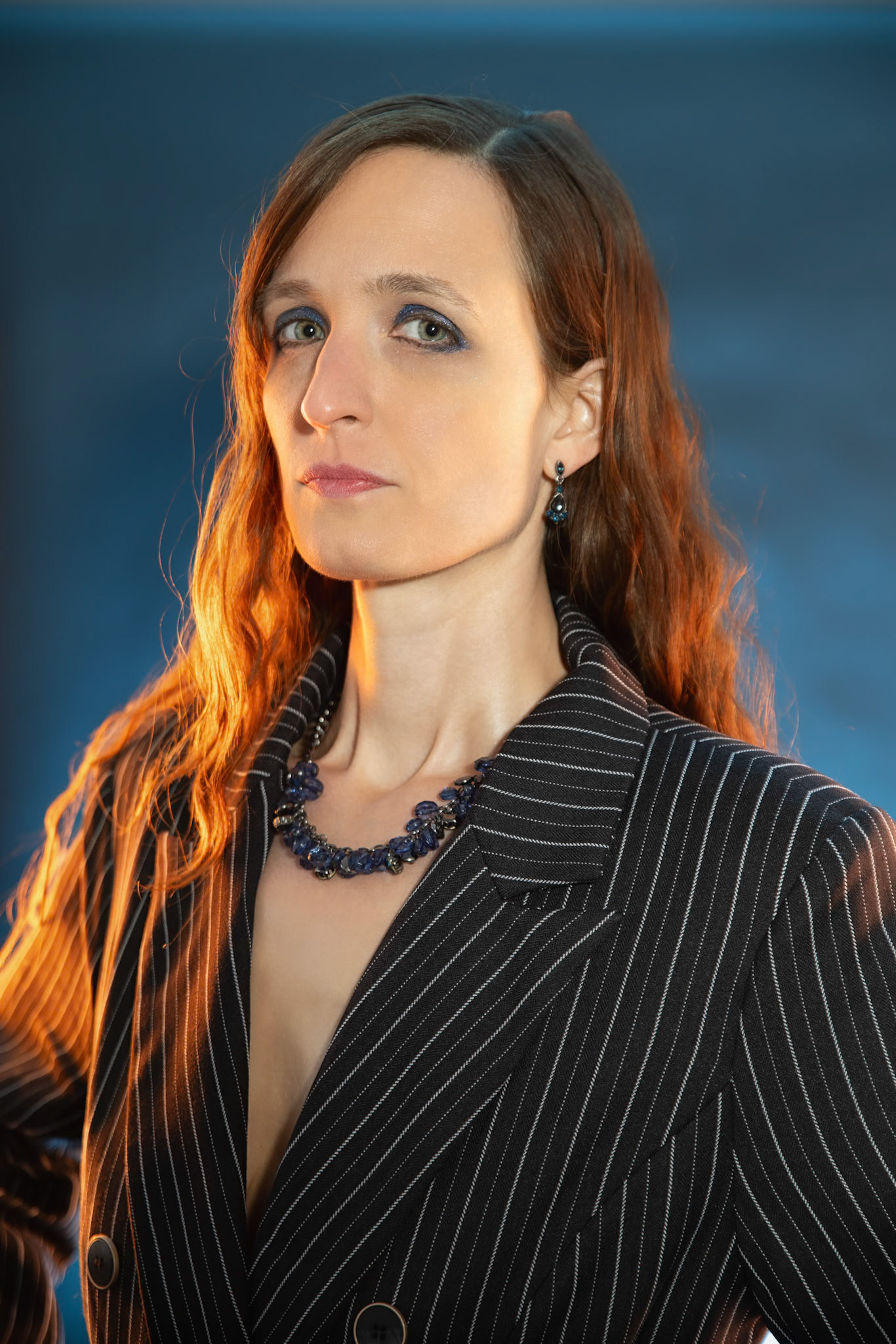 Short Skirt and a Long Jacket - Arm Back: Cake themed shoot today, lit by the sides by Godox AD200 pros in 30x120 softboxes with yellow gel. Backlight lit by V1 with a blue gel. Main flash also a V1 with a grid and white cloth softener.