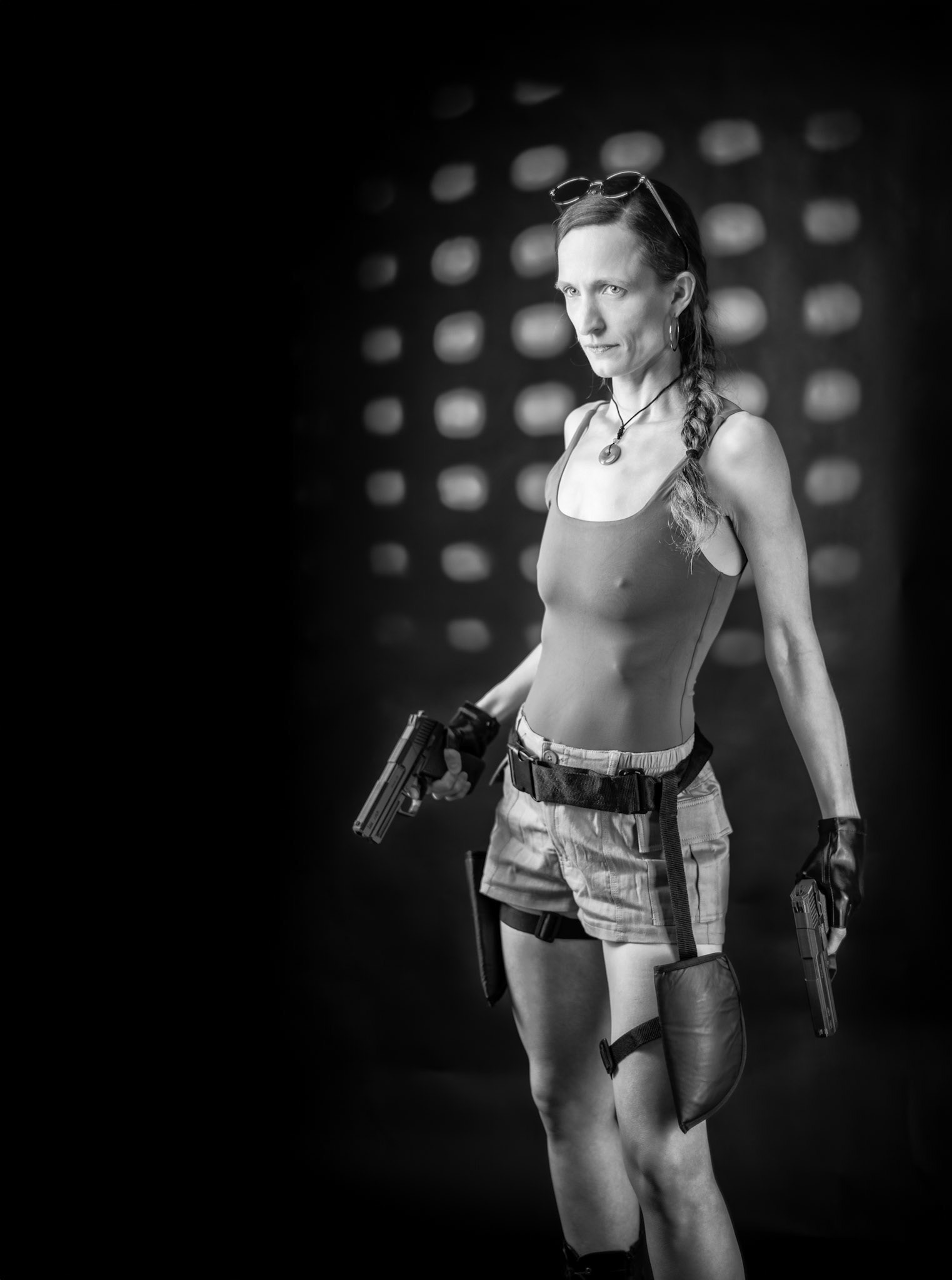 Lara Croft: Ready for the Next Tomb Adventure (B&amp;W) - This Lara Croft cosplay brings the Tomb Raider spirit to life with 3D-printed prop guns that turned out way better than I expected. Flashpoint XPlor 600 for the primary spotlight, Godox AD200 or V1P in 120×30mm soft boxes for fill, and a Godox AD200 with a 3D-printed gobo to add that dramatic backlight.