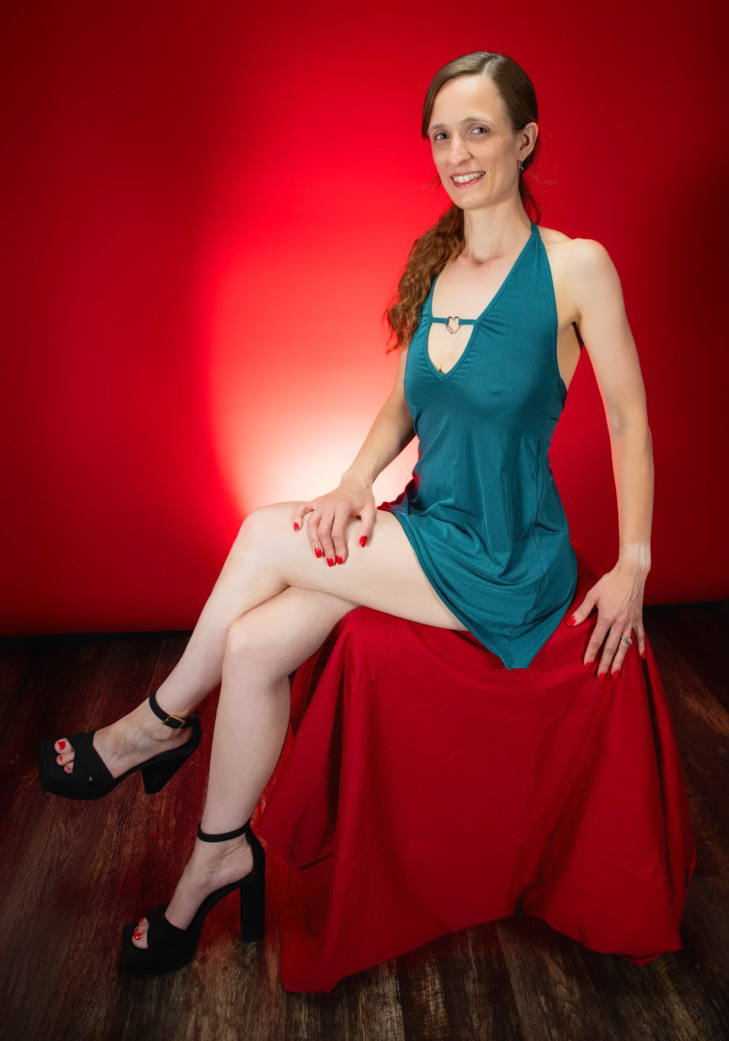 Little Teal Dress - Seated: Taking advantage of rain, we setup a new backdrop from Prime week and some new dresses. Godox V1 above and on backdrop (with red gel). Godox AD200 front left and front right for fill light in 120x30 softboxes.