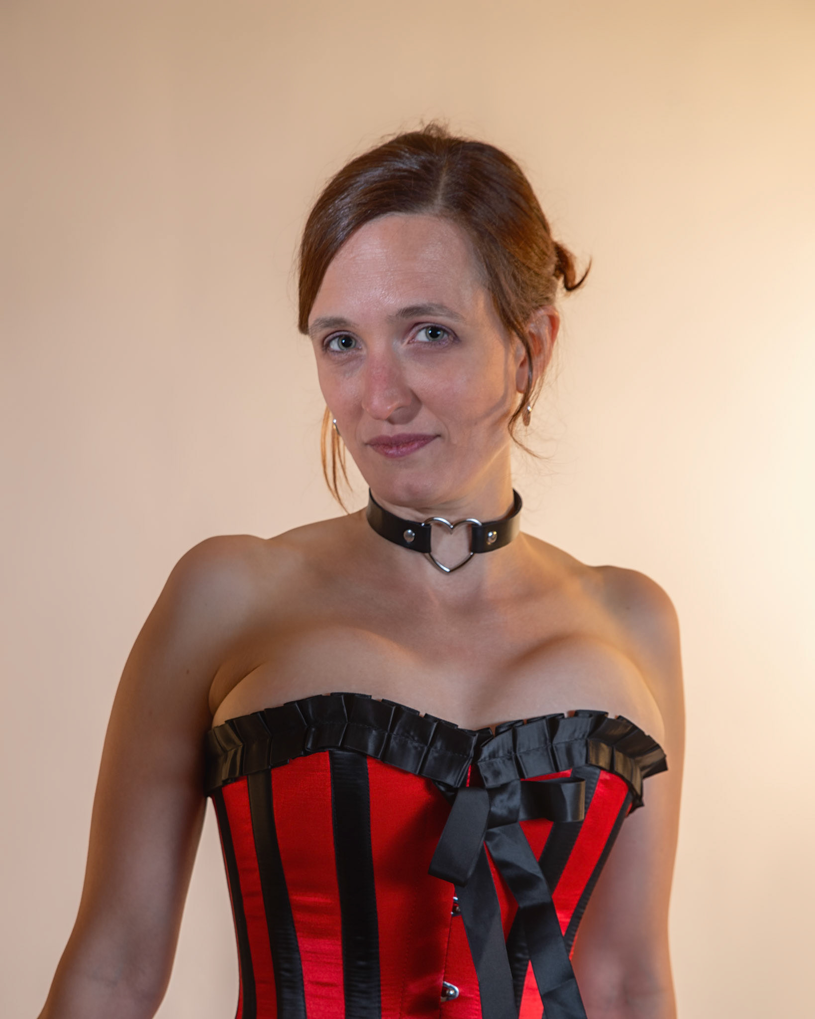 Western Corsetry - Close Up: Bringing back out the western themed corset outfit for a final run at studio shots with the seamless backdrop. Godox v1 with 7" reflector front left, 30x120 softbox with another Godox V1 right side, and Godox AD200 w/ Yellow gel lighting the backdrop.