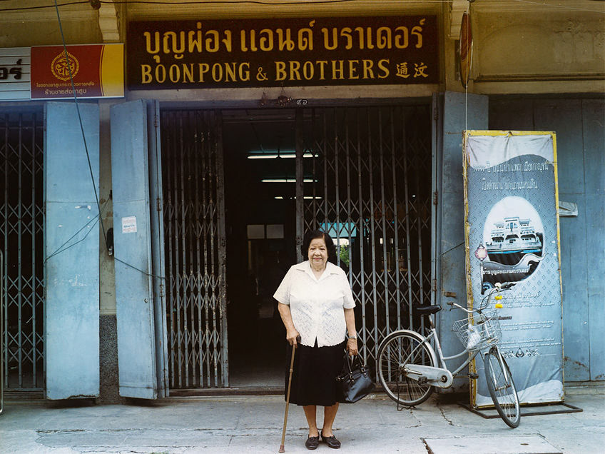 Mrs Boonpong poses outside her brother's Chemist in Kanchanaburi city. A chemist by trade, he was also a member of the Thai resistance movement that worked to undermine the Japanese occupation. Mr Boonpong regularly provided medical supplies to resistance members that were able to get across the river and to the prison camps in order to supply the prisoners with crucial provisions, risking his life in the process. My own grandfather’s appendix was removed in the camps; surgical tools were either fashioned from found objects or acquired through such covert operations. Mrs Boonpong and her family preserve the original shop in the old part of the city. I came about them by chance on a hunt throughout the city for a new battery for my Bronica camera. My presence in the non-touristic part of the inner city attracted curiosity, after a few translations from passers by I found myself cycling behind a police woman’s car on her day off to introduce me to the Boonpong family.