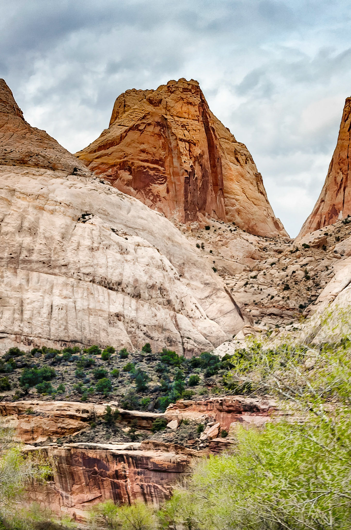At left of this image is part of "Navajo Dome", one of the dramatic geologic features found in the Capitol Reef National Park, Utah, USA.. This park is so named for the white sandstone "domes" and cliffs of the Navajo sandstone formation that are reminiscent of the United States Capitol building in Washington, DC. Navajo Dome is the eroded remnant of buried ancient sand dunes that were cemented over time by minerals then subsequently, exposed by erosion over the past millennia.