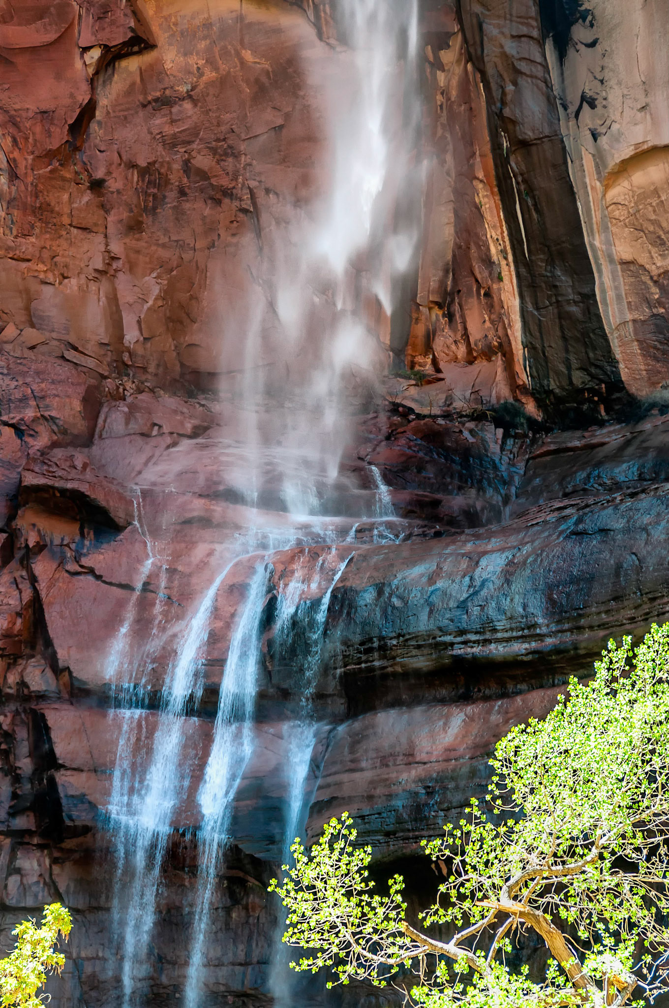 Spring runoff water tumbles over the sheer cliff walls of Zion Canyon, Utah, USA, falling into the north fork of the Virgin River below.