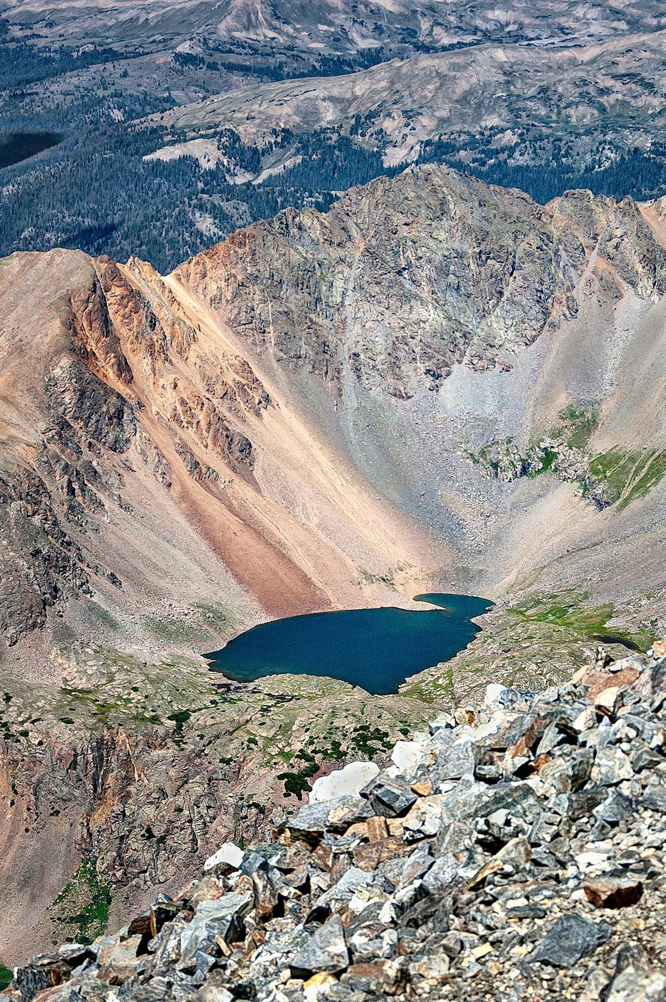 Chihuahua Lake, is a tarn lake (or corrie loch), formed by past glacial action. Resting at an elevation of 12,400 ft, (3,780 m), Chihuahua Lake is viewed here from the summit of Grays Peak, (14,270 ft = 4,350 meters).