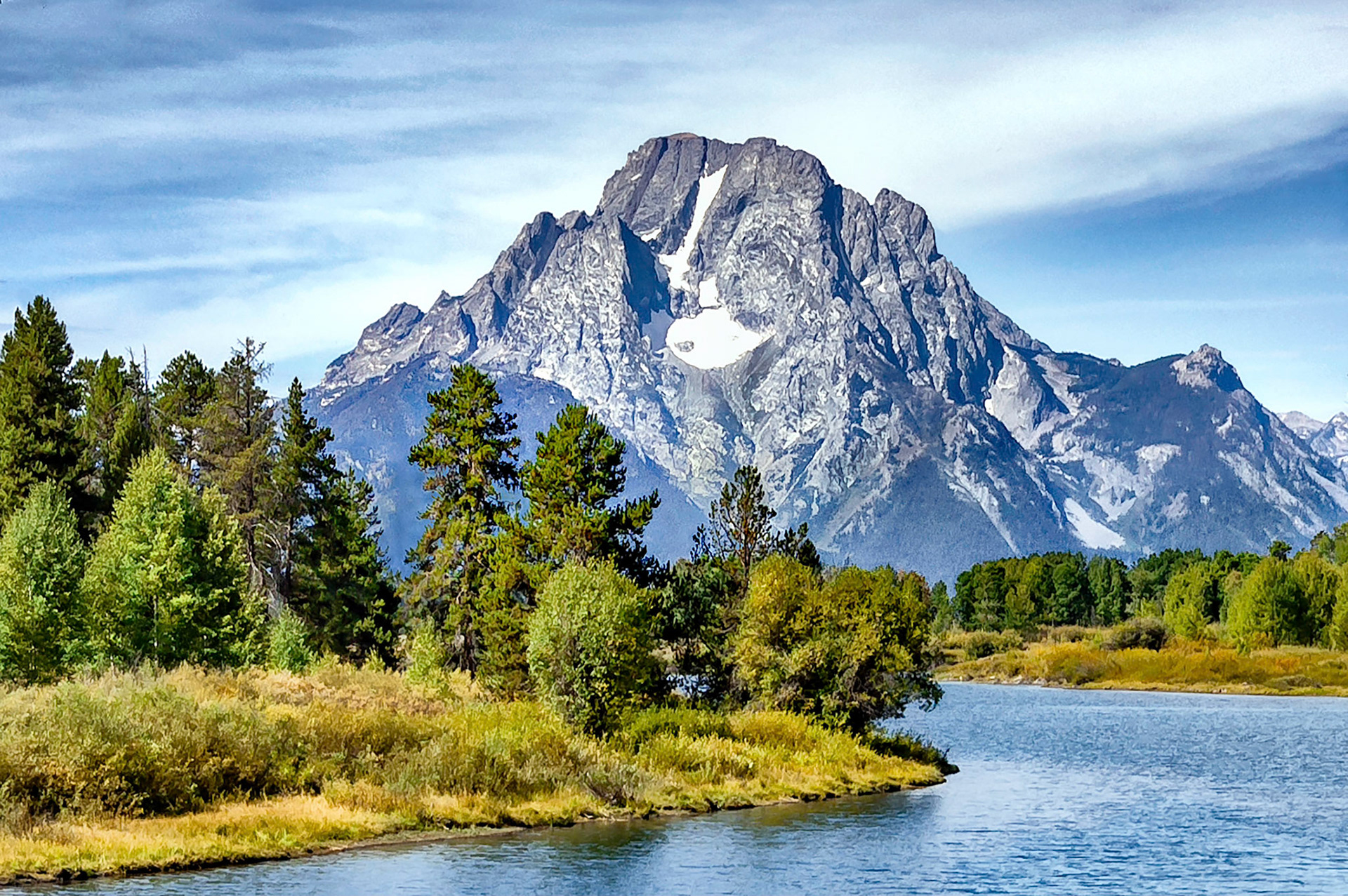 The Snake River winds across the plains below the iconic Mount Moran, (12,605 feet = 3,842 m). Mount Moran, named after the western artist Thomas Moran, lies at the northern end of the Teton Ranges in the Grand Teton National Park, Wyoming, USA.
