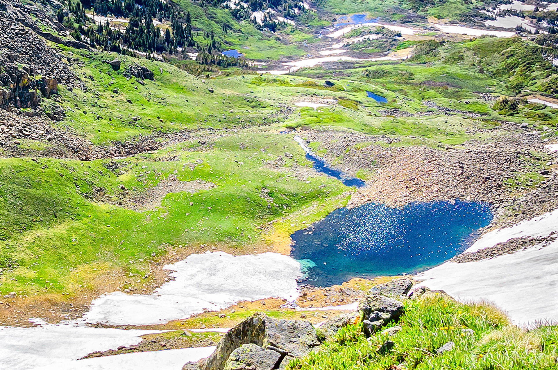 Crystal clear snow melt waters collect in Lake Bob, a tarn lake formed in the ancient glacial moraine and scree rocks on the east side of the USA continental divide near Rollins Pass, Colorado.